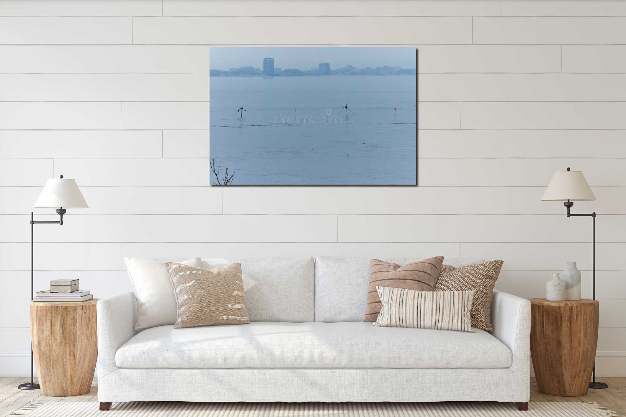 Serene landscape featuring calm sea water with distant buildings and silhouettes of birds perched on poles, creating a tranquil interior mockup