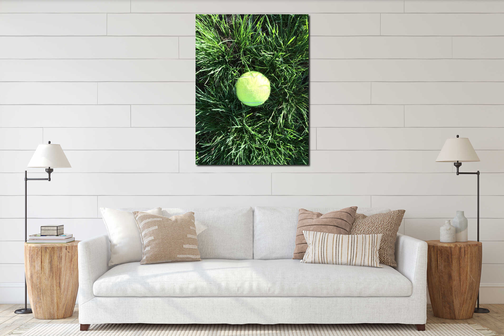 A lime-colored tennis ball laying in the tall green grass in the sunlight a vertical macro flatlay photo for sports interior mockup