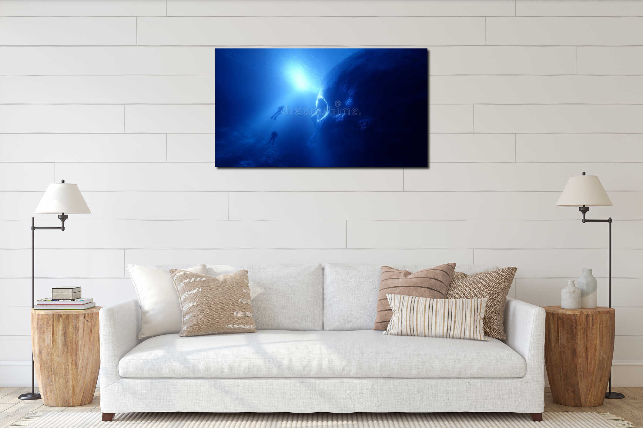 A deep dive into the mysterious ocean. Explore the beauty of underwater life. Two divers swim gracefully near large rock formation interior mockup