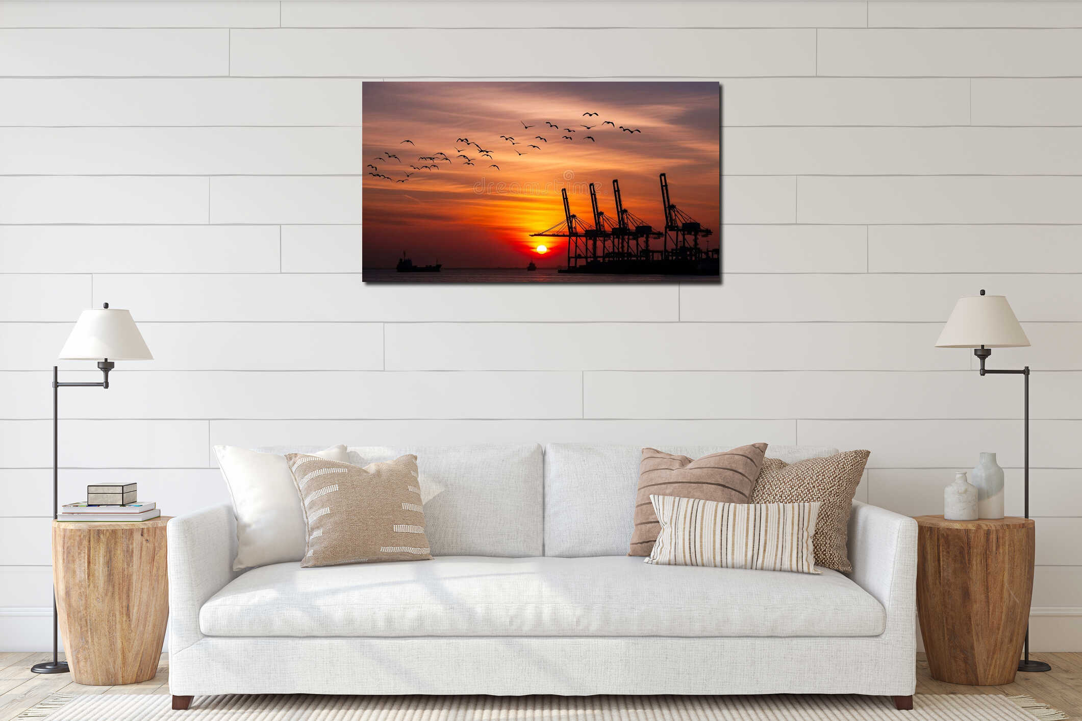 Stunning sunset silhouettes industrial port cranes and flock of birds flying over calm ocean water interior mockup