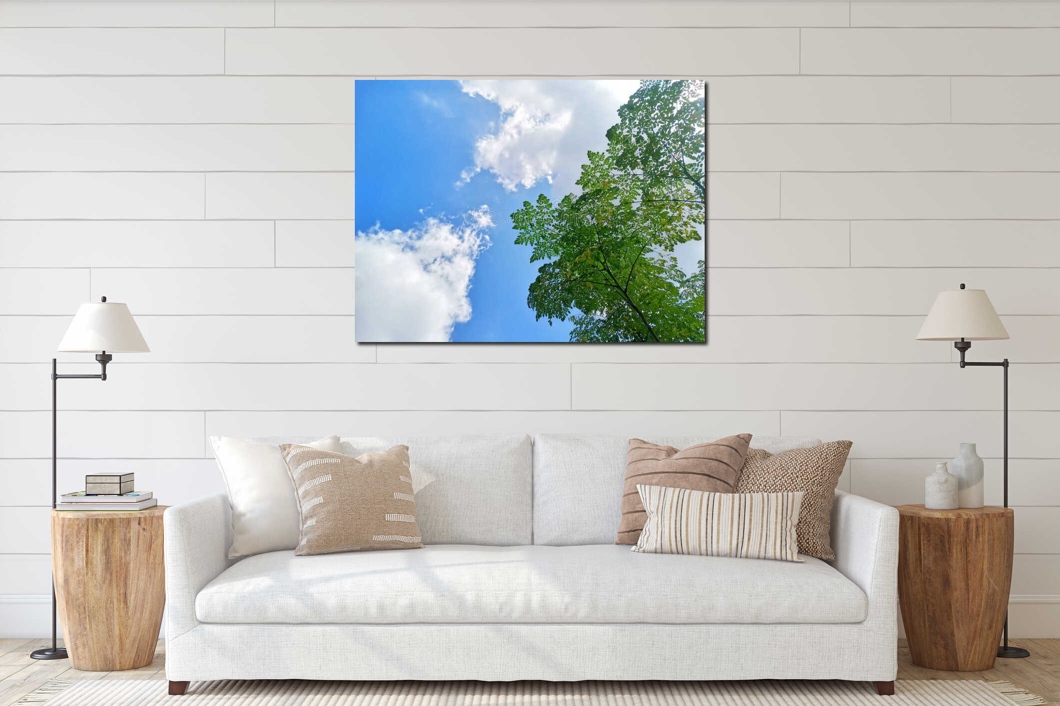 A bright blue sky filled with soft white clouds stretches above interior mockup
