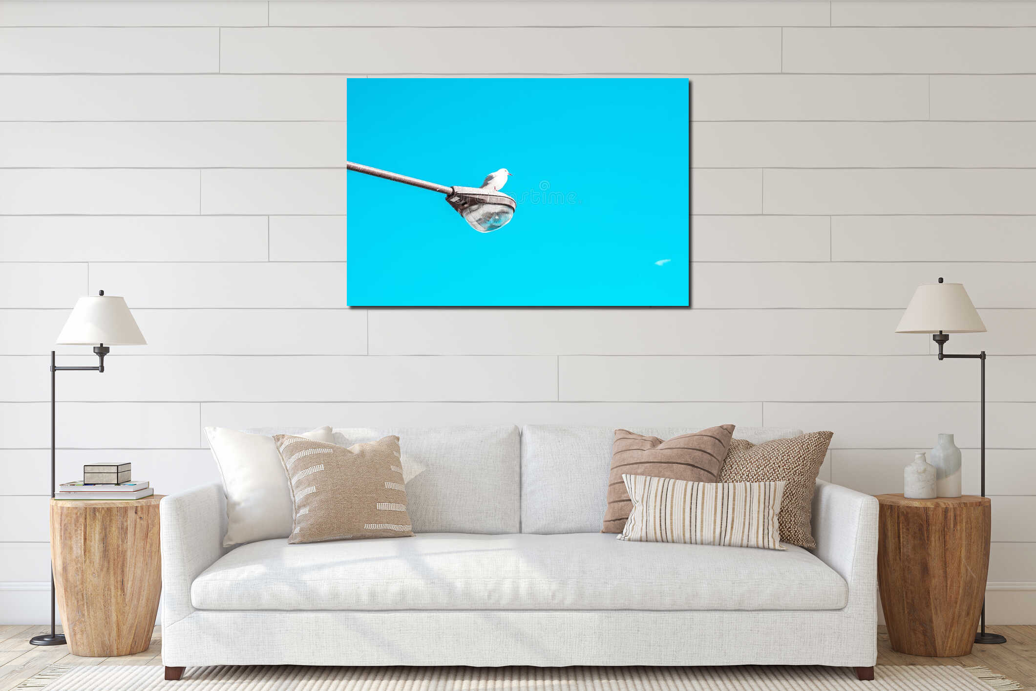 Seagull perched on a street lamp against a clear blue sky interior mockup
