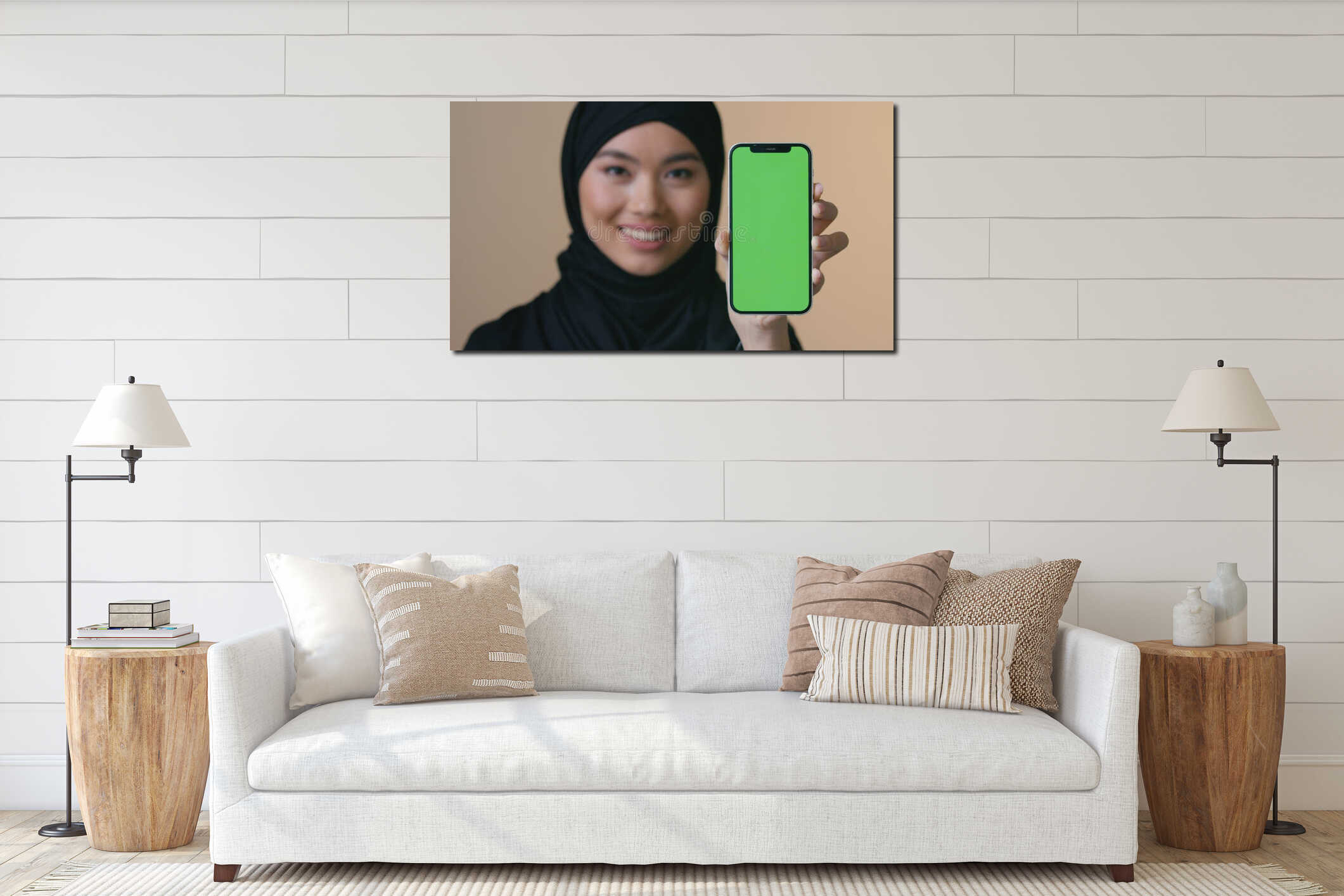 Smiling Asian Muslim woman in black hijab holding smartphone green screen looking at camera promo female showing mobile interior mockup