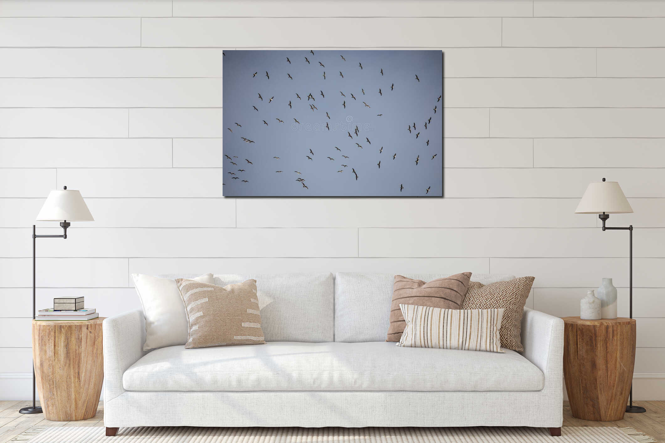 A large flock of seagulls spreads across the sky above PÃ³voa de Lanhoso. interior mockup