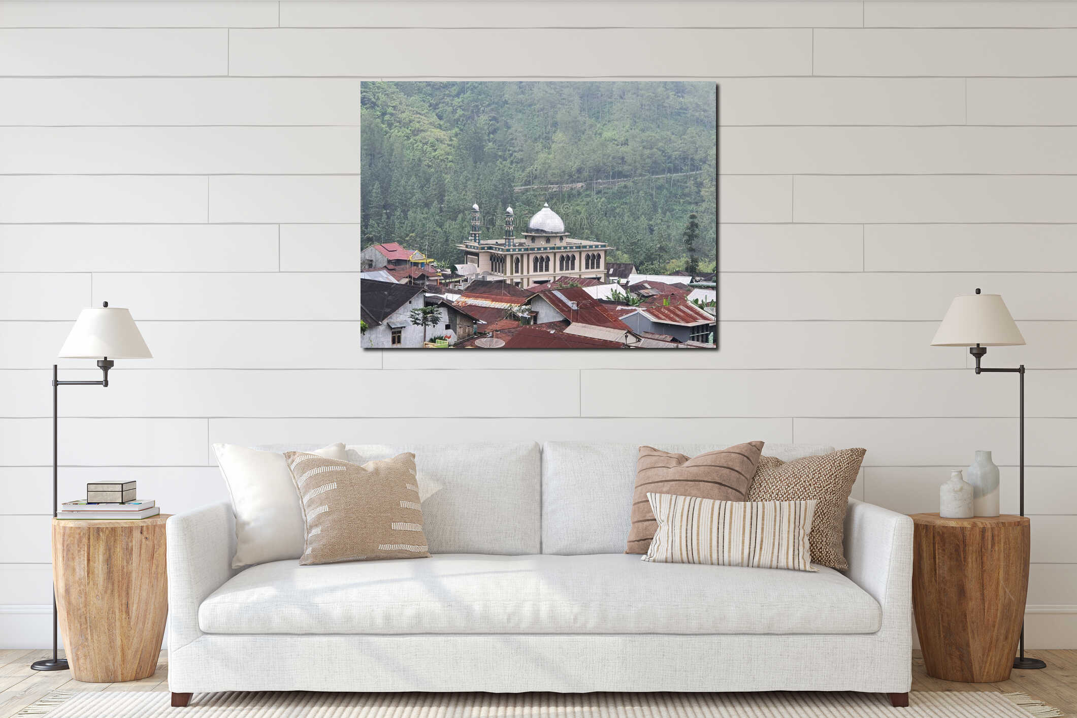 Mosque with silver domes standing among village houses with rusty roofs in a forested valley interior mockup