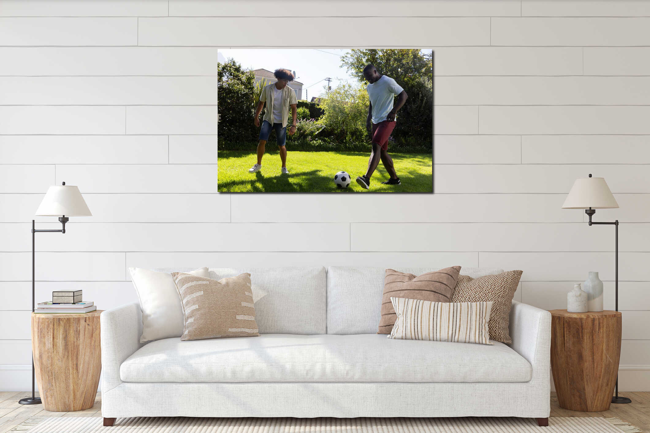 Diverse male friends wearing shorts playing soccer on green lawn in yard with ball interior mockup
