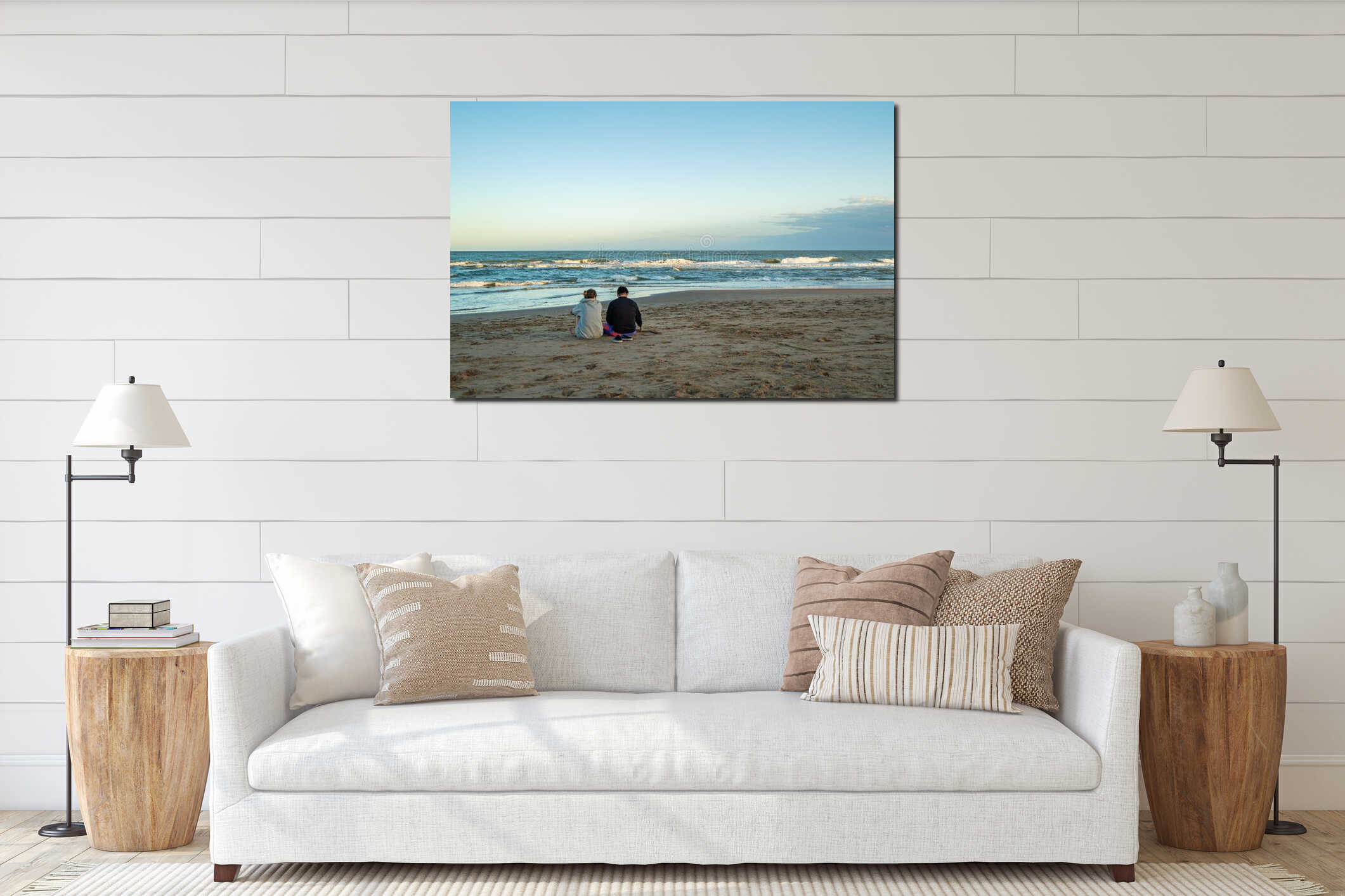 Two people sitting on the beach, one of them is wearing a black jacket interior mockup