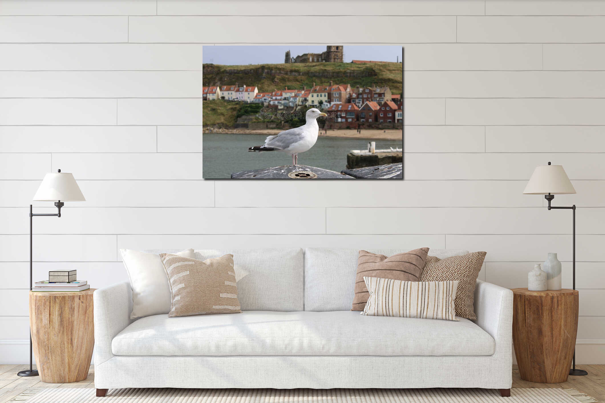 Seagull standing on a harbor railing overlooking the coastal town of Whitby in England interior mockup
