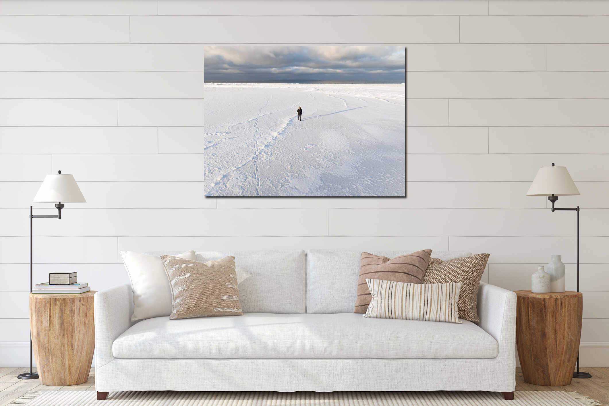 High angle aerial drone view of a lonely person walking on the frozen Baltic Sea covered in white snow in Finland interior mockup