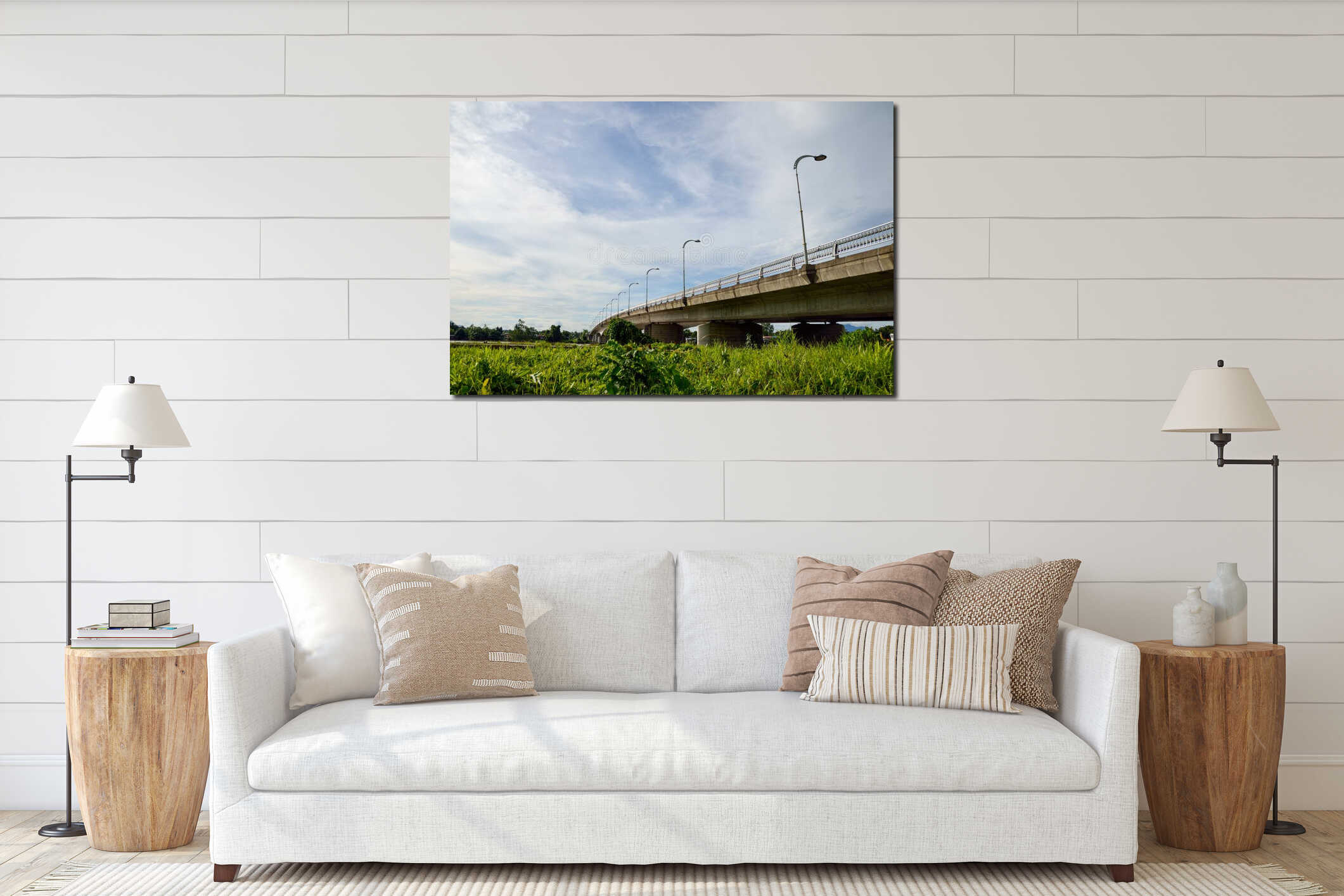 A low-angle shot of a modern concrete bridge stretching across a green landscape under a blue sky interior mockup