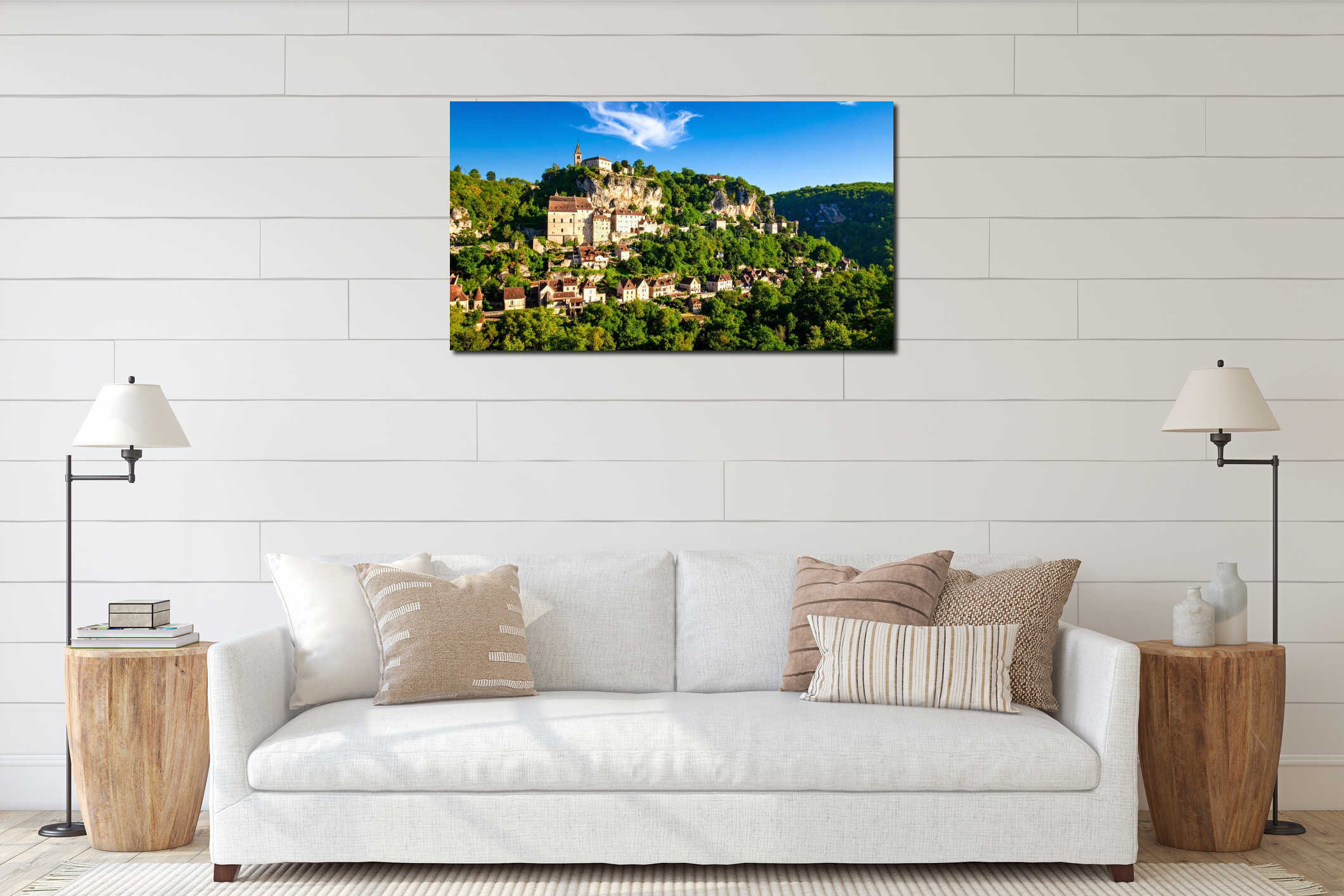 Scenic view of a historic village perched on a cliffside, surrounded by lush greenery under a bright blue sky. interior mockup