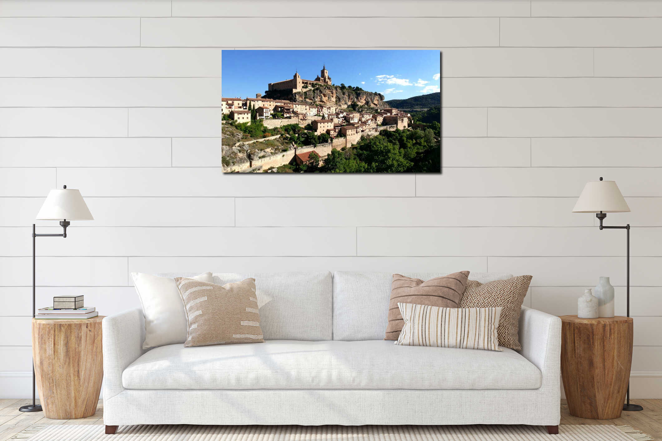 Scenic view of a historic village with castle on a cliffside under a clear blue sky interior mockup
