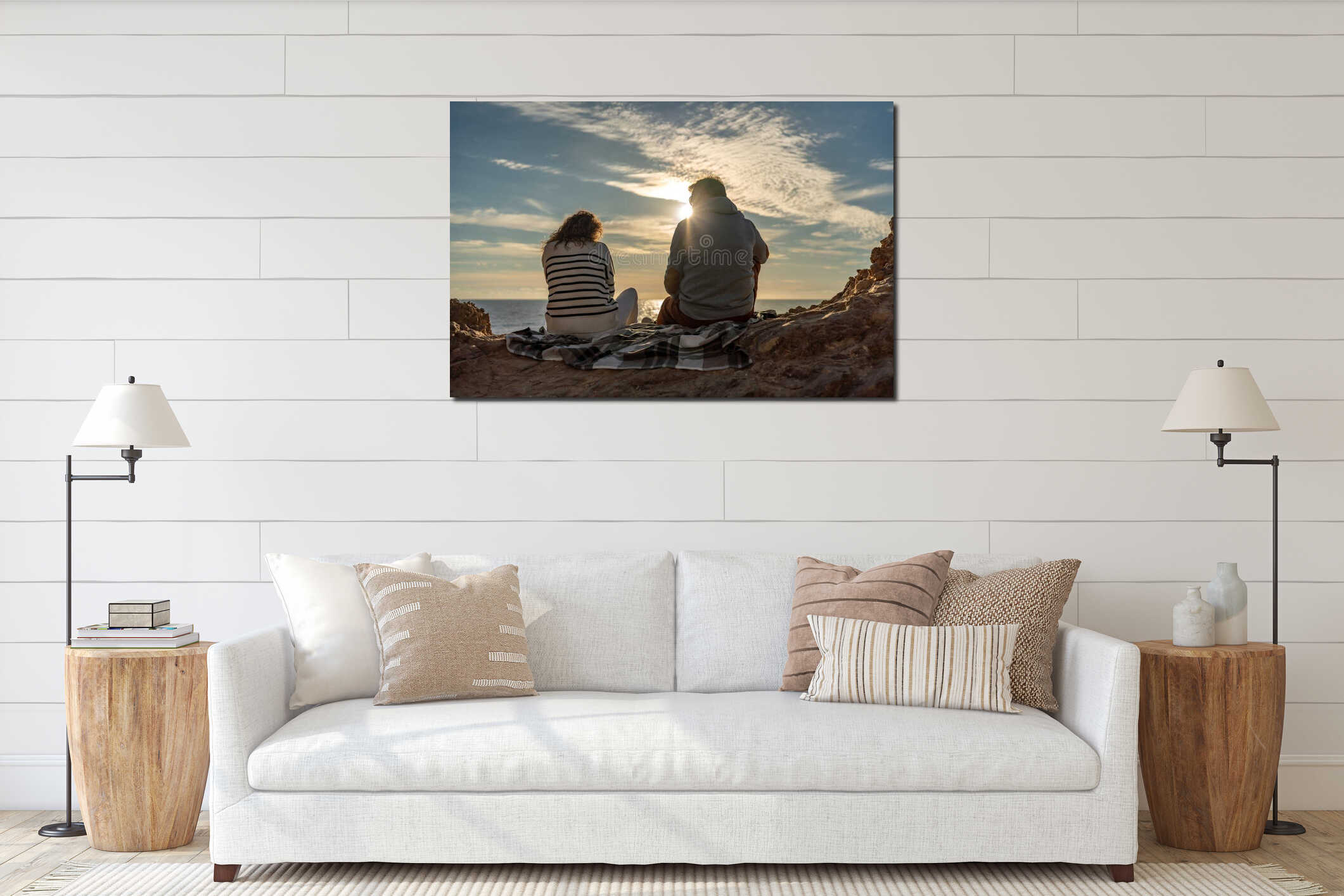 Couple sunset ocean view sitting on coastal rocks during a peaceful romantic evening interior mockup
