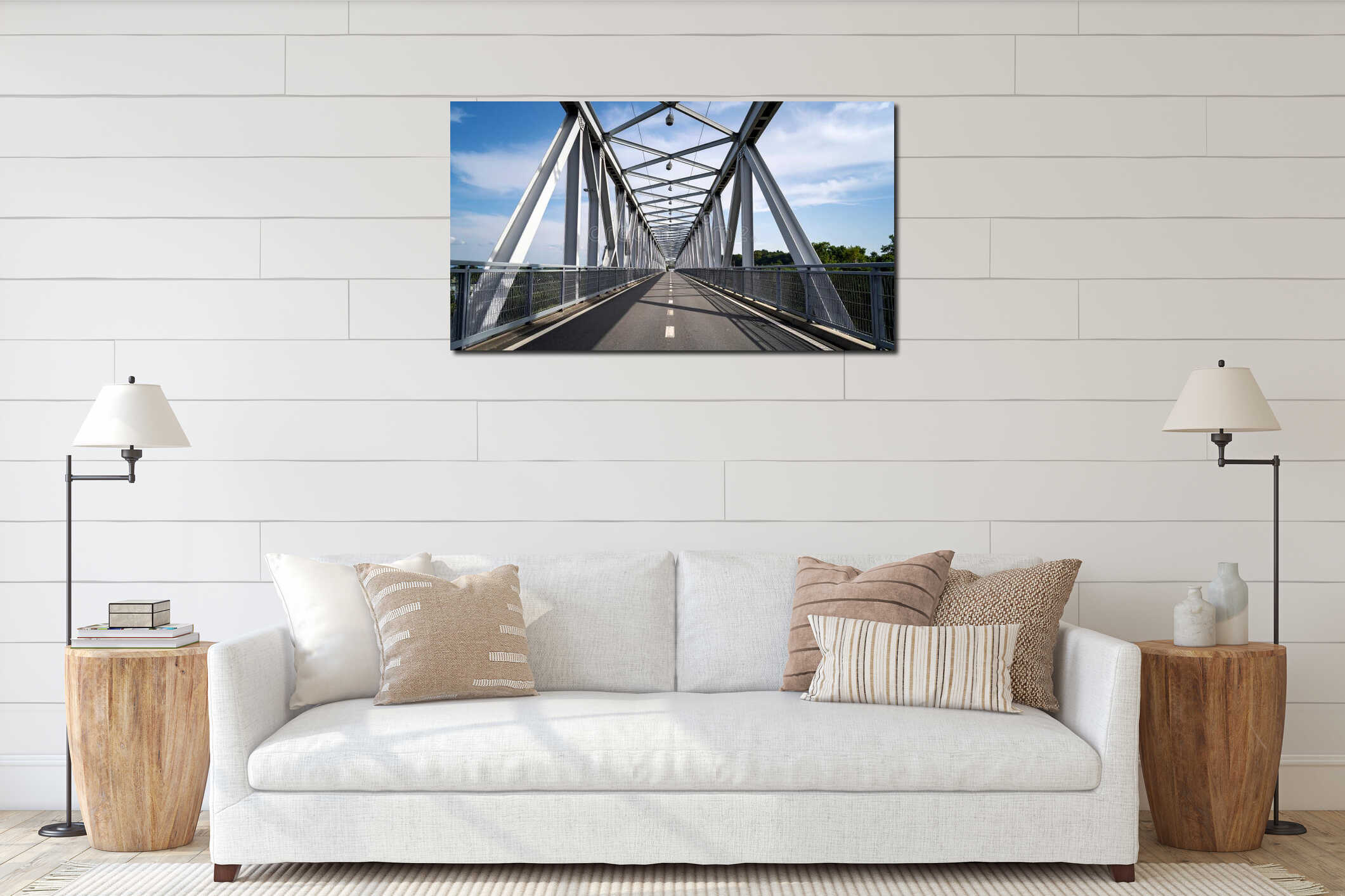 Metal bridge structure spanning a river with a road and walkway under a blue sky interior mockup
