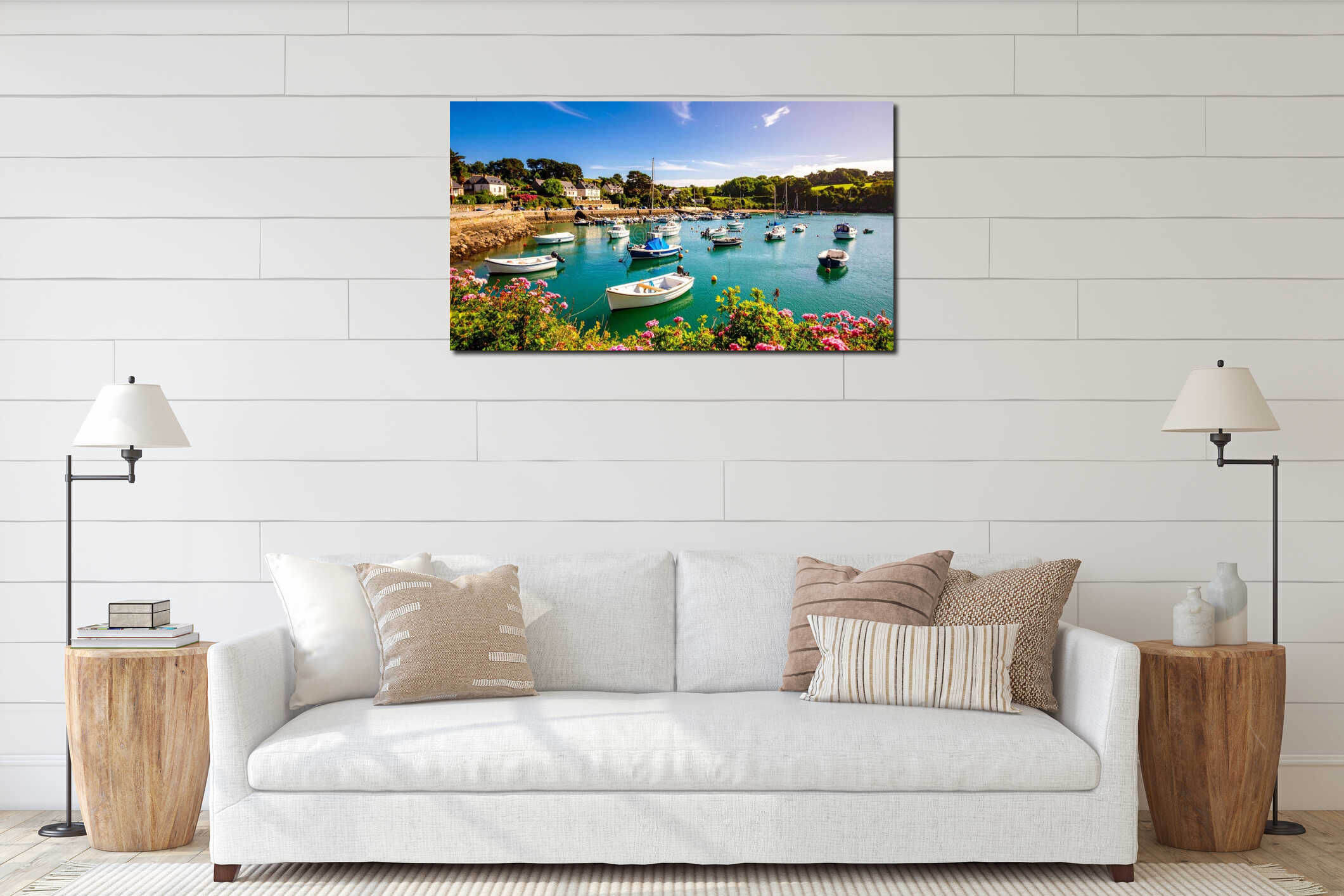 Scenic coastal harbor with boats, houses, and vibrant flowers under a blue sky interior mockup