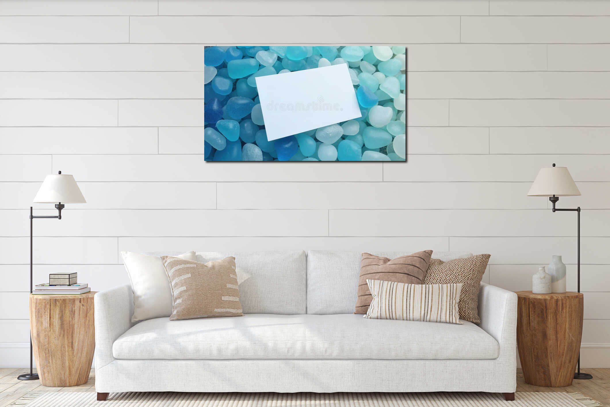 White card rests on smooth blue sea glass pebbles. Peaceful background for text, notes, or messages about ocean beach summer interior mockup