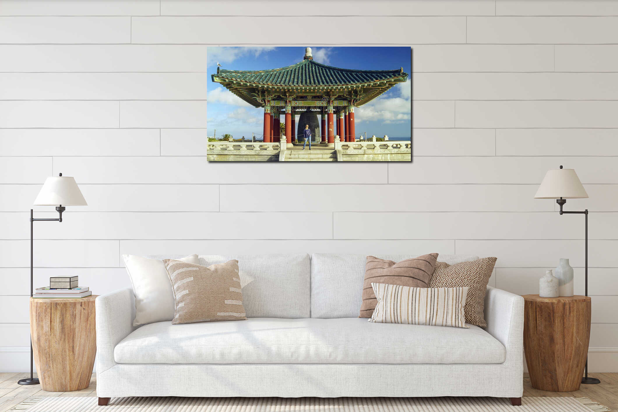 Female tourist stands by the famous Korean Bell of Friendship pavilion in Angel's Gate Park under a sky with white clouds interior mockup