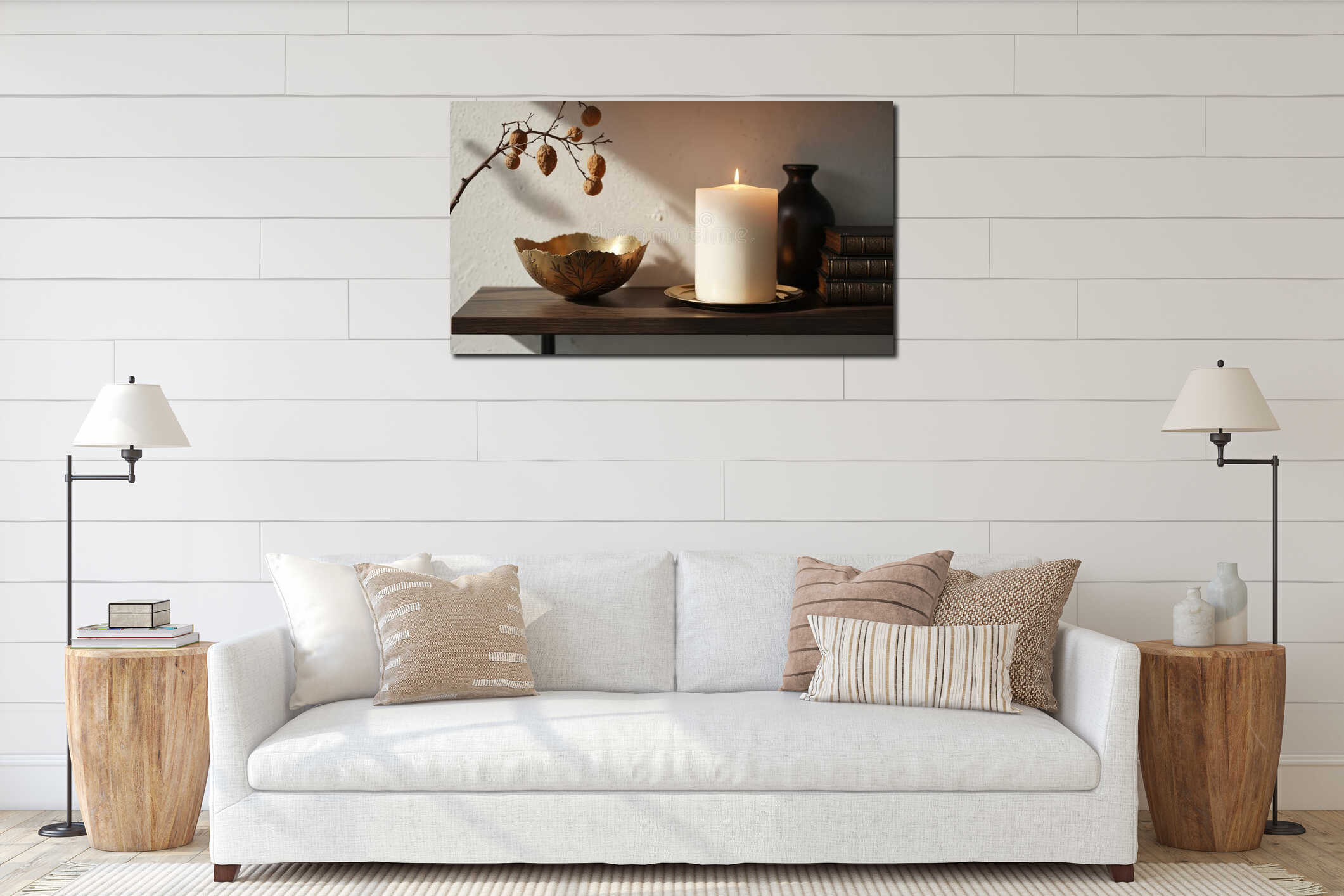 Large white pillar candle burns on shelf with decorative items. Brass bowl, antique books, black vase, and branch with nuts interior mockup