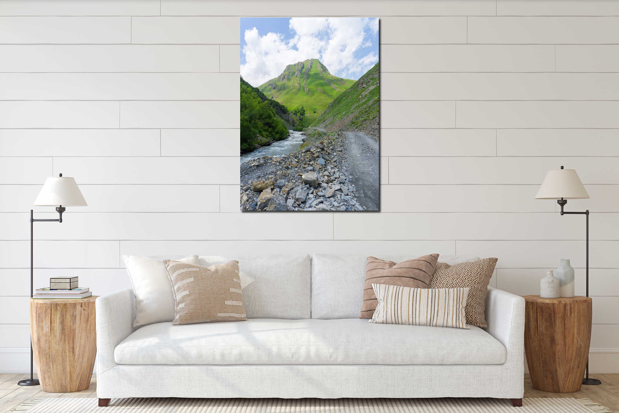 The gravel road runs parallel to the Terek River. Huge stones on the side. Mountain covered with greenery interior mockup
