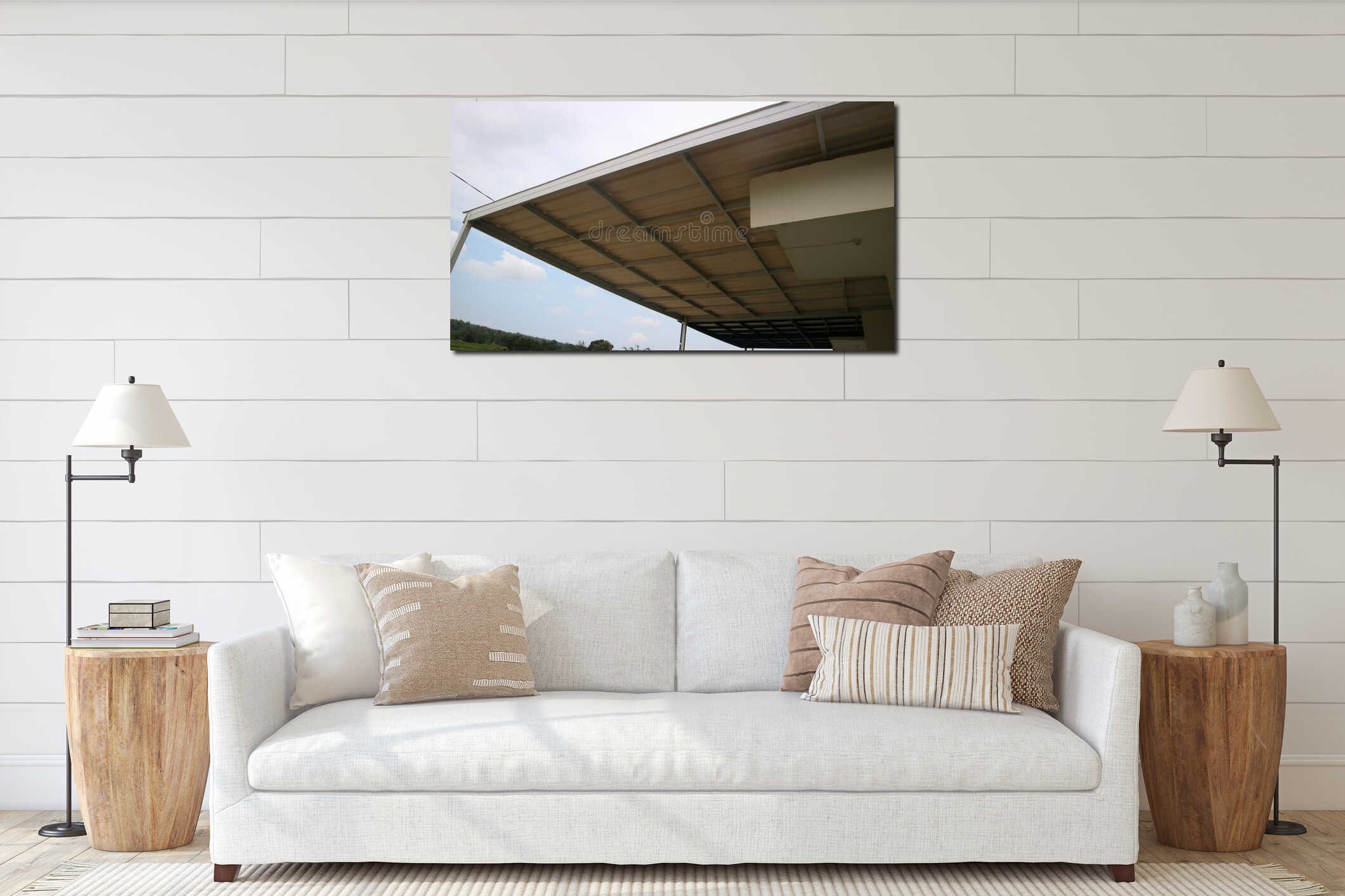 Low angle view of metal roof canopy or carport attached to a building, with beams and corrugated panels against a blue sky, interior mockup