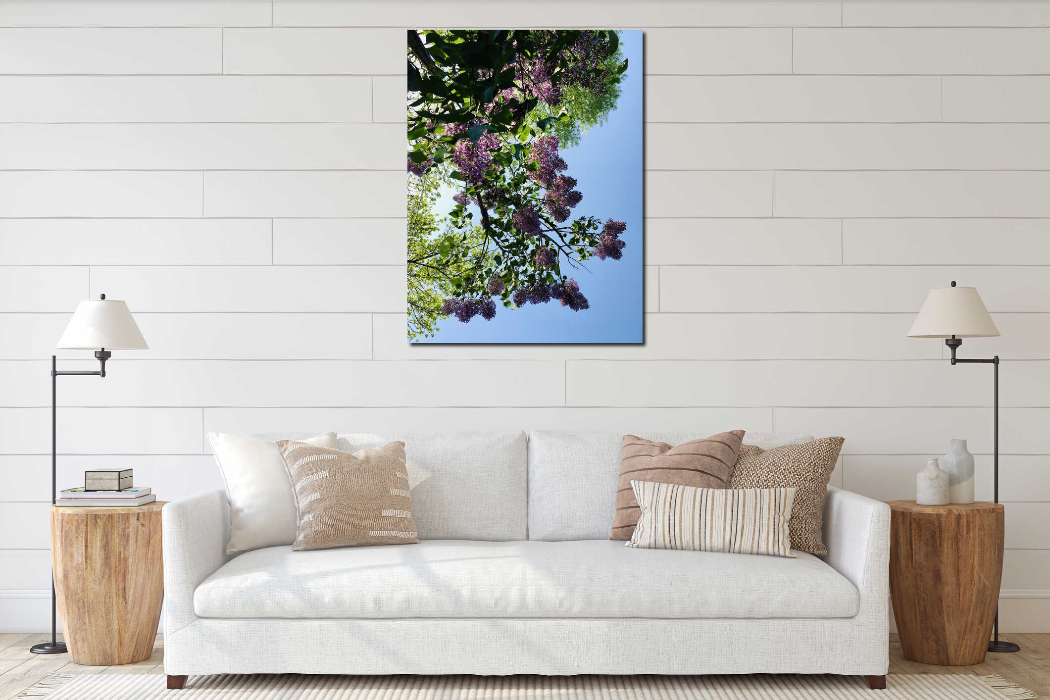 Light-purple lilac with four-petal flowers surrounded with green leaves creating natural pattern against blue sky and trees interior mockup
