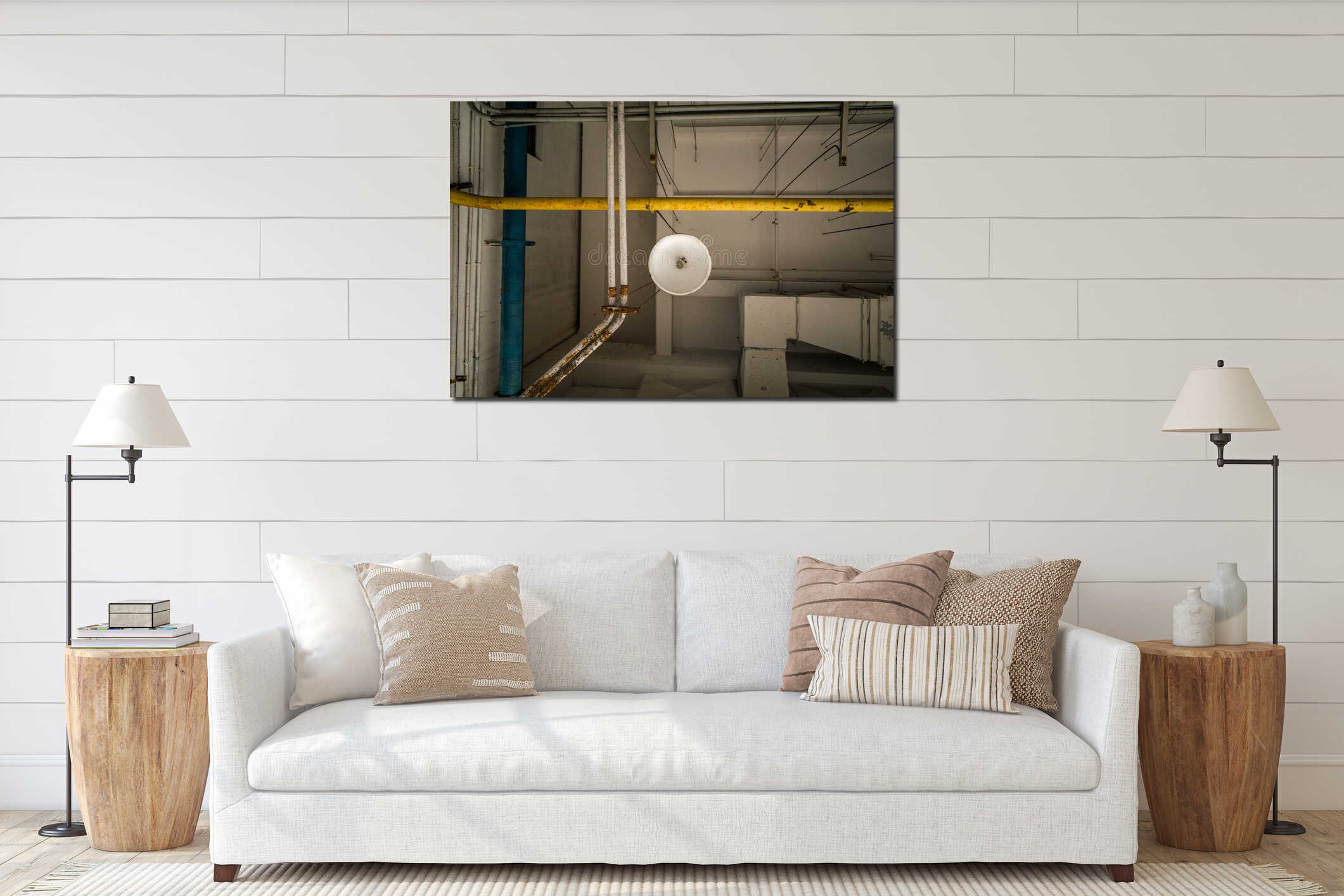 Looking up at a white industrial ceiling with a central light fixture and a grid of yellow blue and white utility pipes. interior mockup