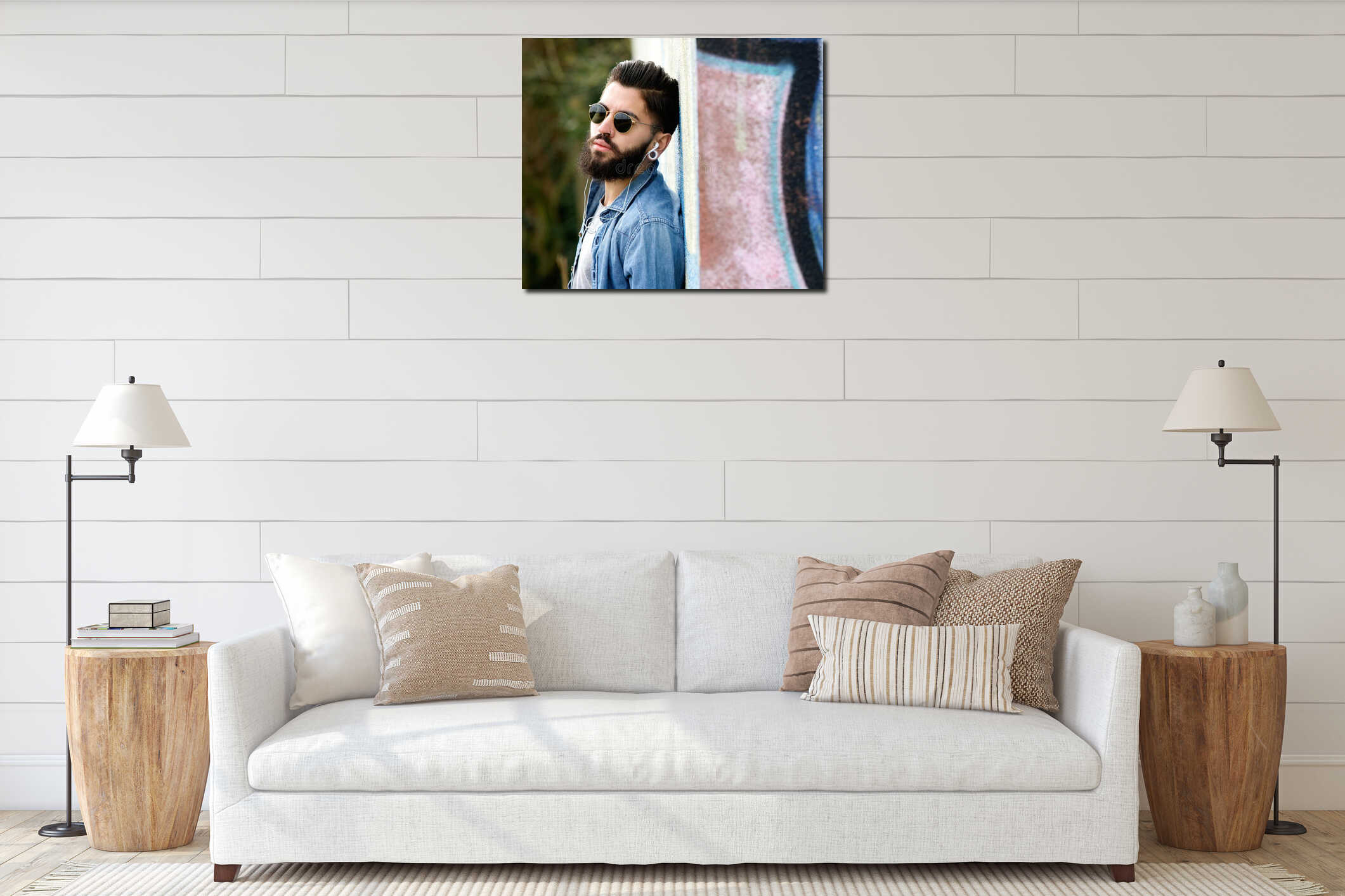 Modern young man with beard listening to music with earphones interior mockup