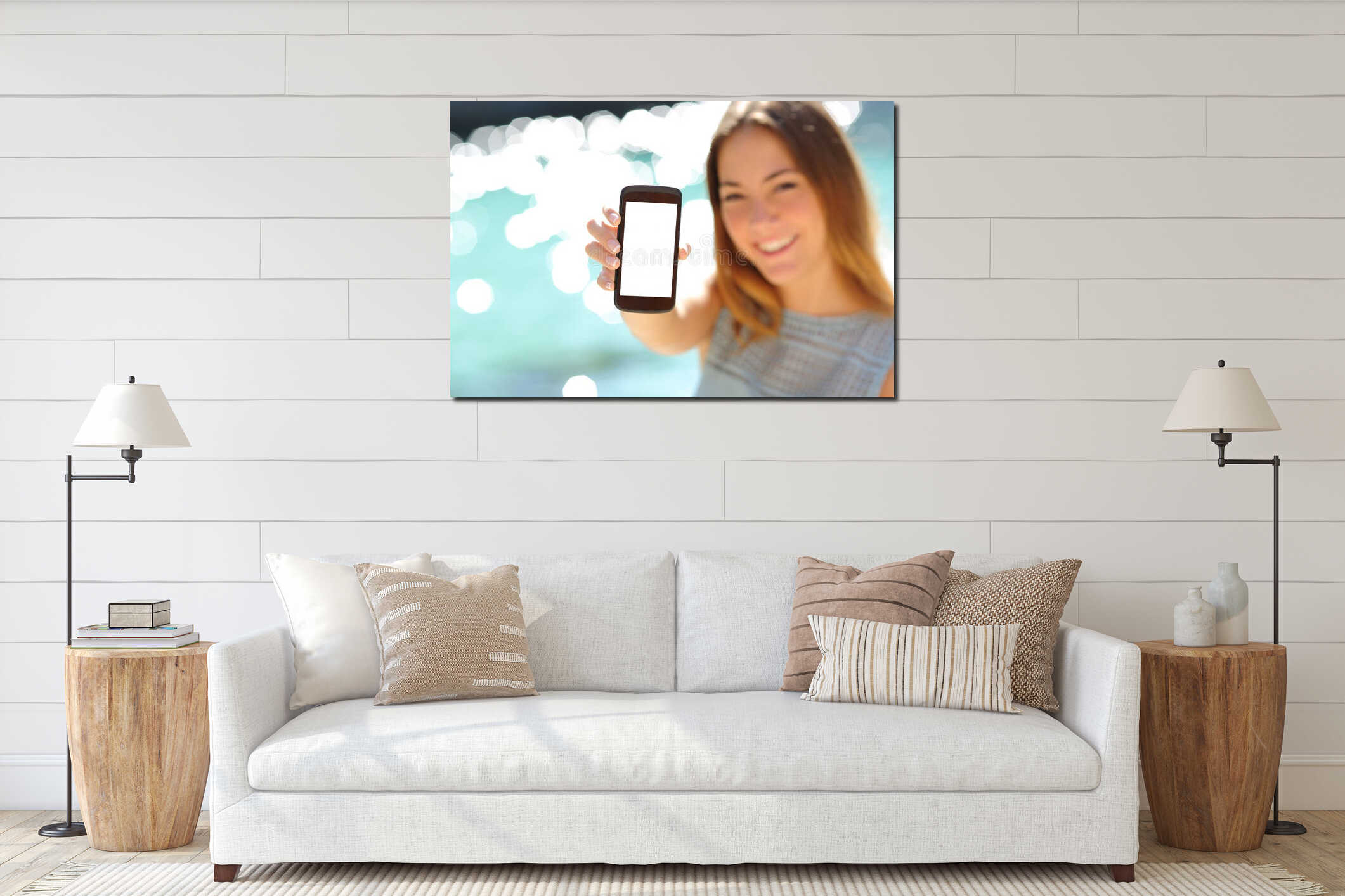 Happy woman showing a blank smartphone on the beach interior mockup