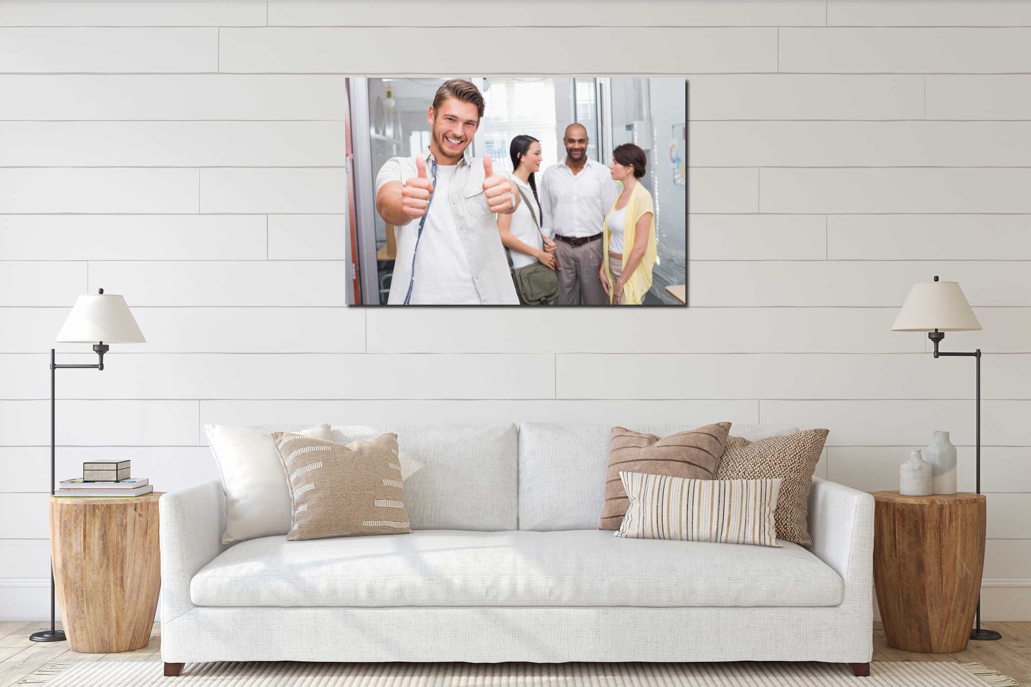 Man giving thumbs up at camera in front of his colleagues interior mockup