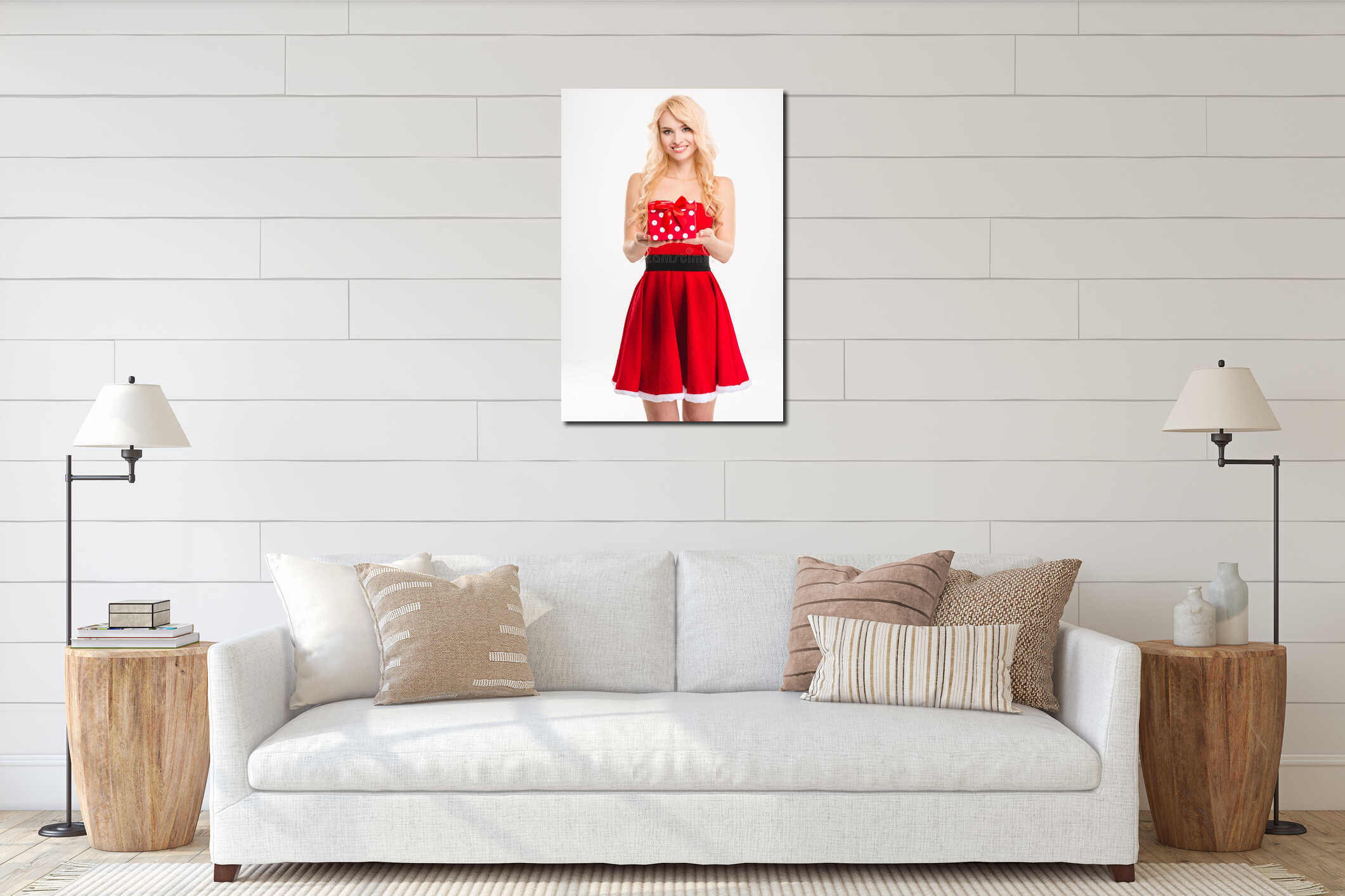 Cheerful blonde girl in red santa claus costume holding present interior mockup