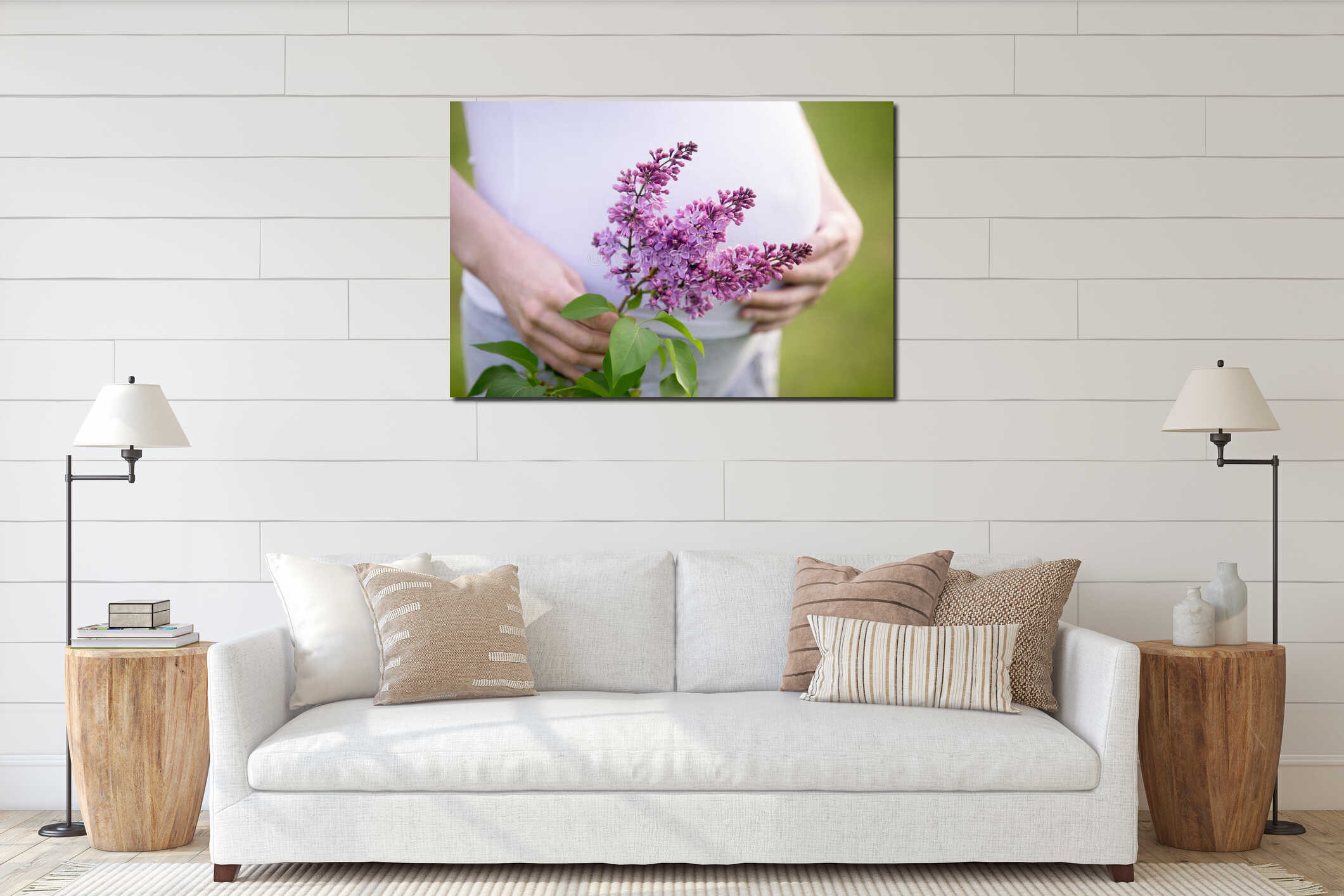 Close-up of torso of pregnant woman holding lilac flower outside interior mockup