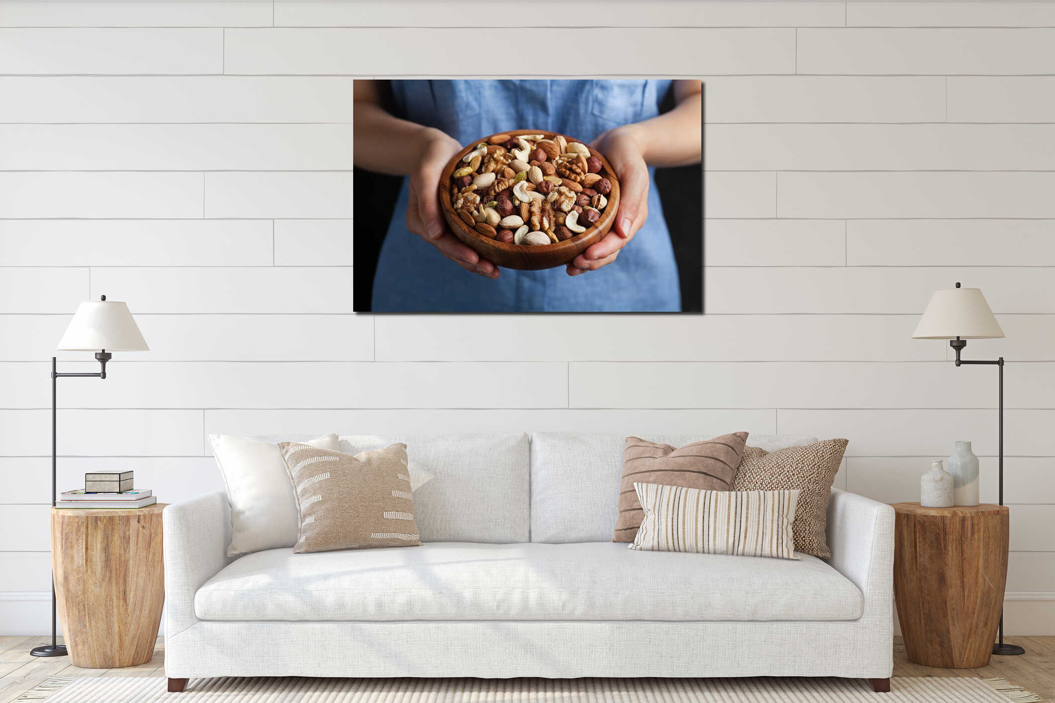 Womans hands holding a wooden bowl with mixed nuts. Healthy food and snack. Walnut, pistachios, almonds, hazelnuts and cashews. interior mockup