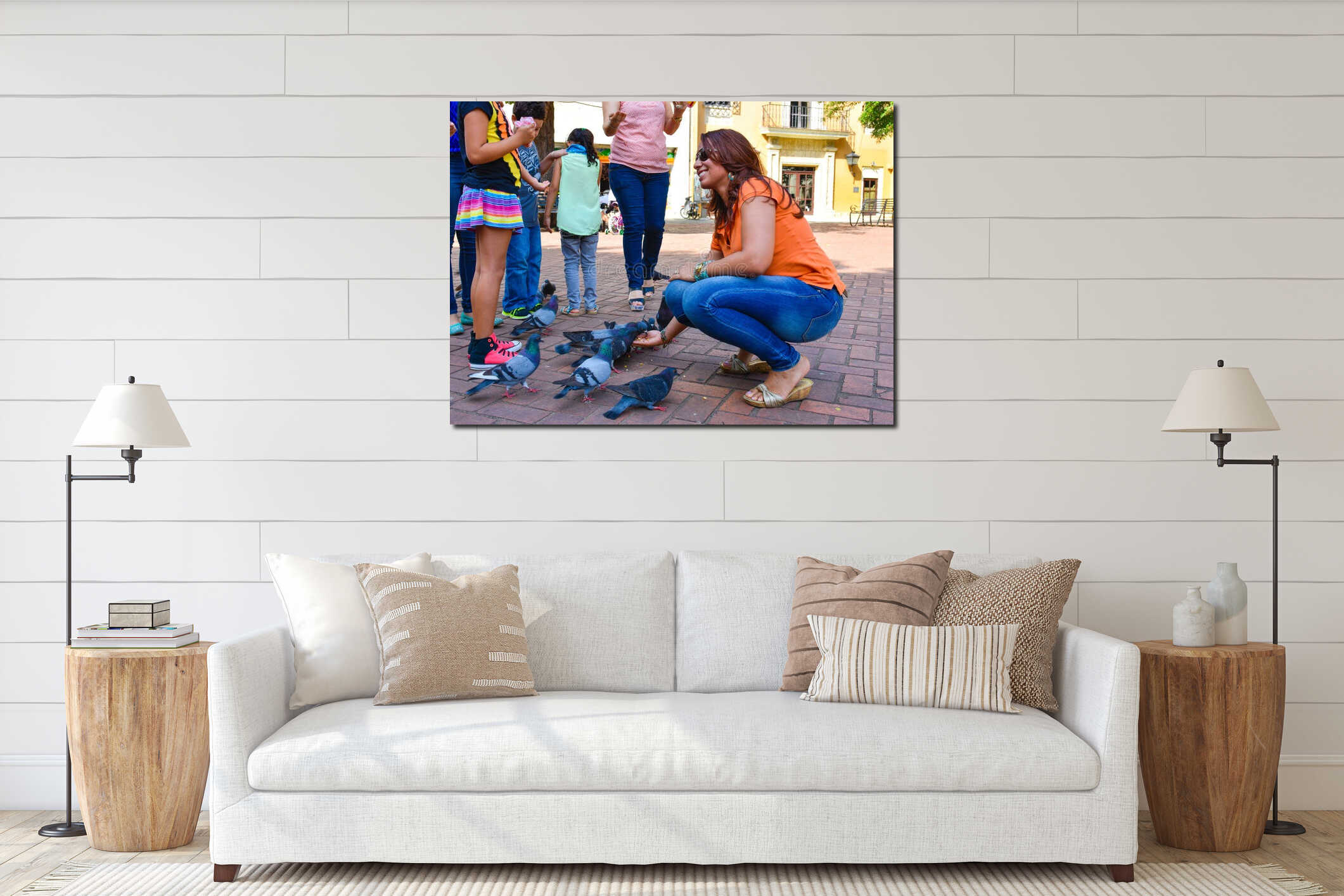 Santo Domingo, Dominican Republic. Woman feeds pigeons on Columbus Park, Colonial Zone of Santo Domingo. interior mockup