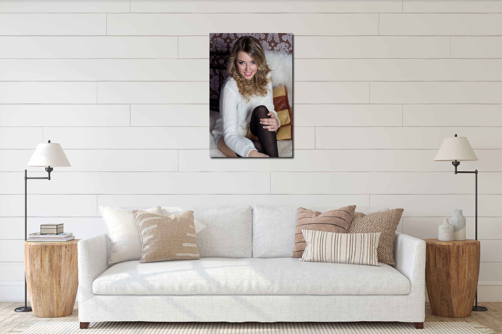 Beautiful cheerful cute girl with a bright smile snow-white sitting in a warm sweater and socks in bed interior mockup