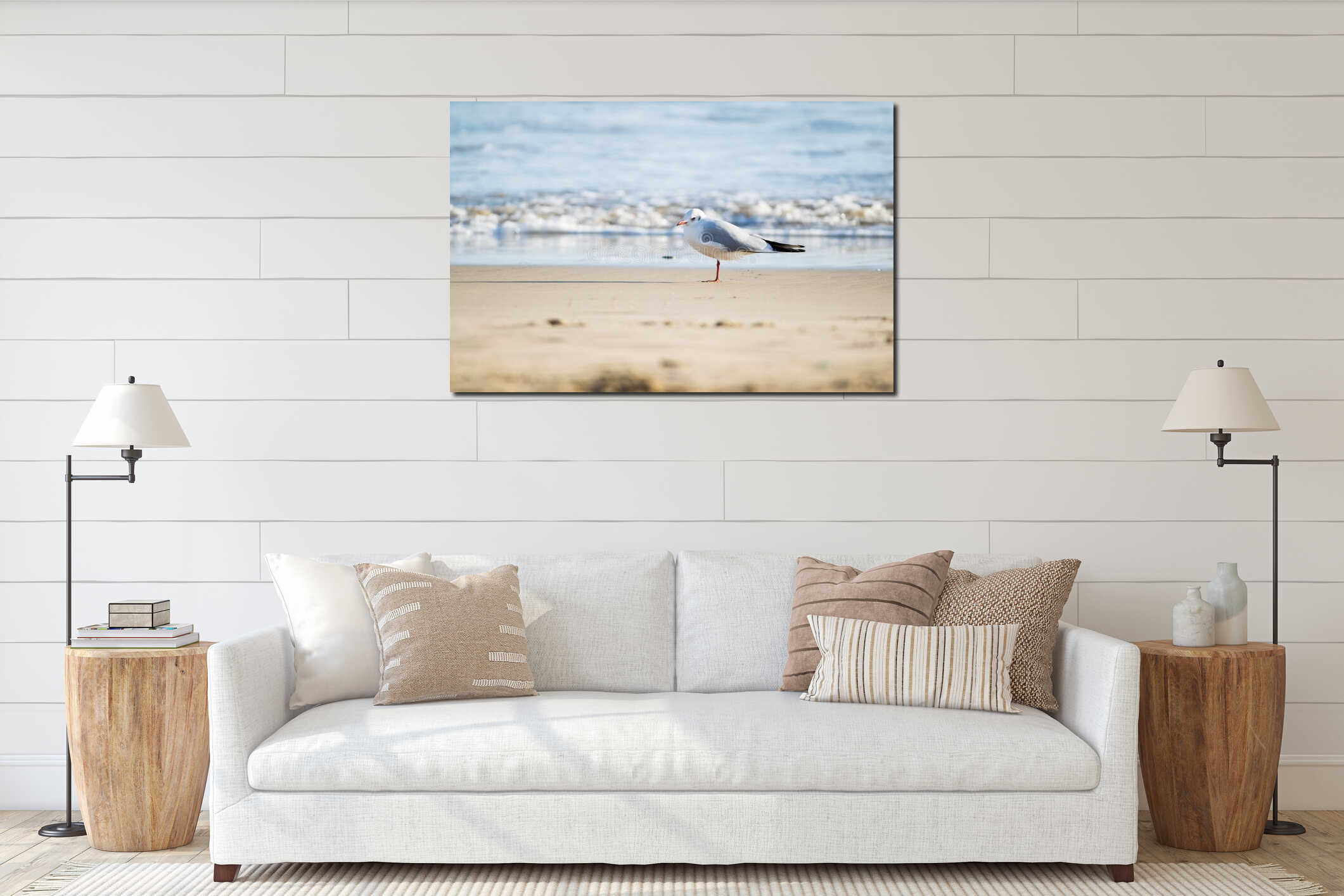 Seagull standing on sand beach in front of the sea interior mockup