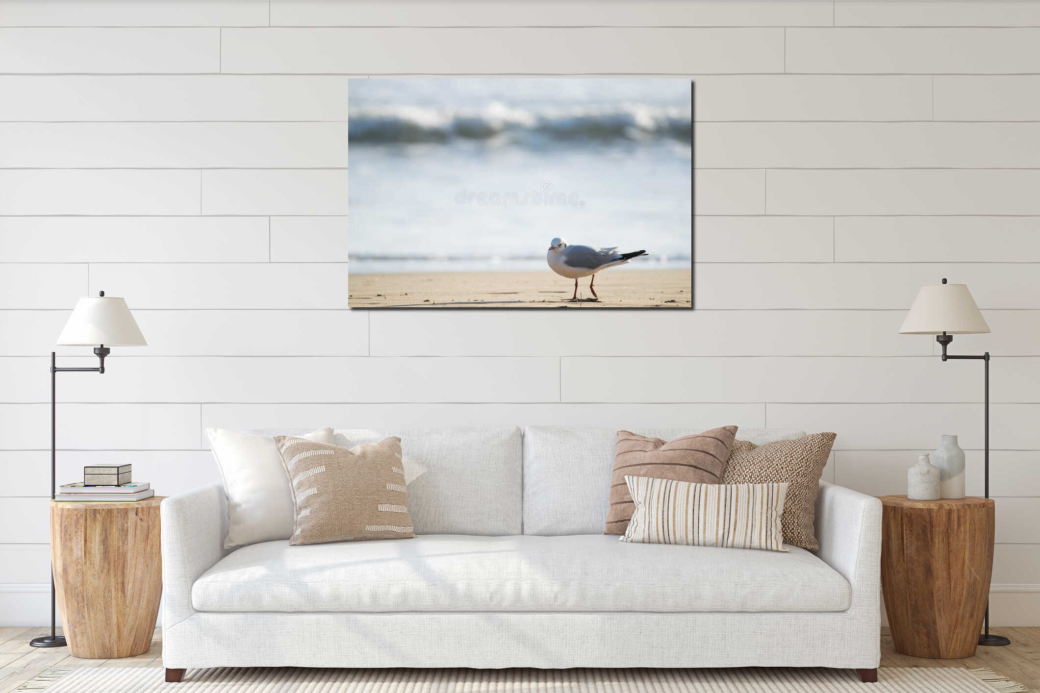 Seagull standing on sand beach in front of the sea interior mockup