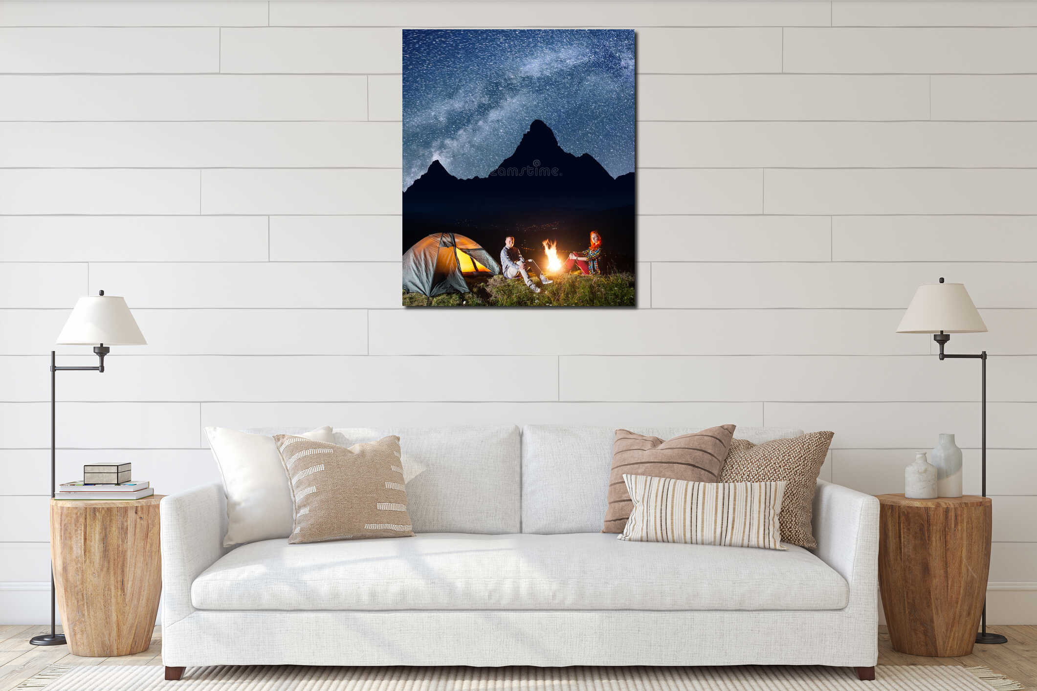 Happy couple tourists sitting near campfire and tent under incredibly beautiful starry sky at night. Long exposure interior mockup
