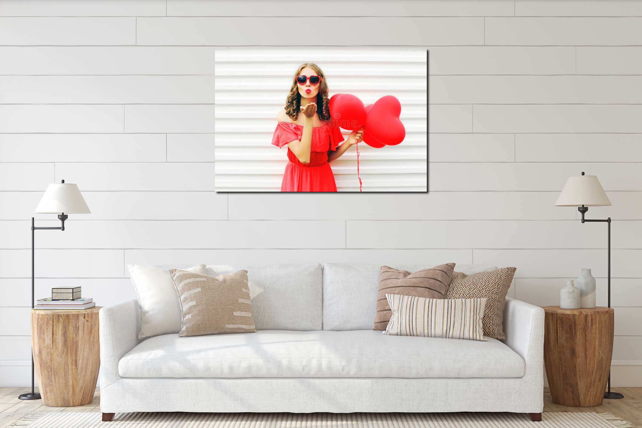 Portrait cute woman in red dress sends air kiss with balloon heart shape over white interior mockup