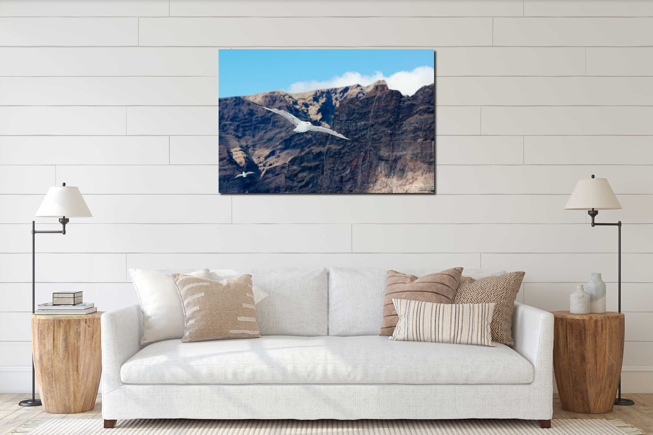 White seagull flying over ocean near rocky cliffs interior mockup