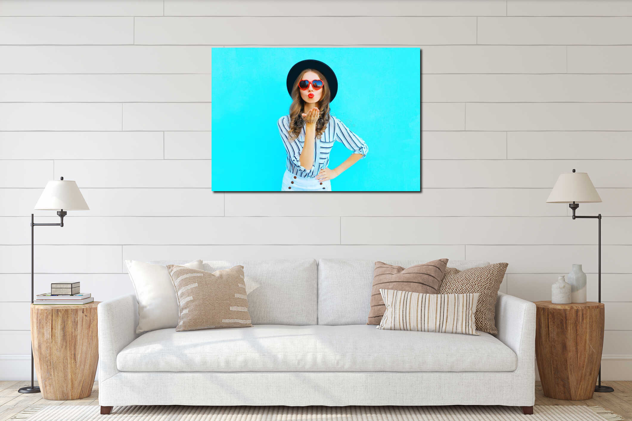 Fashion portrait pretty woman with red lips is sends an air kiss in a sunglasses shape of heart over blue interior mockup