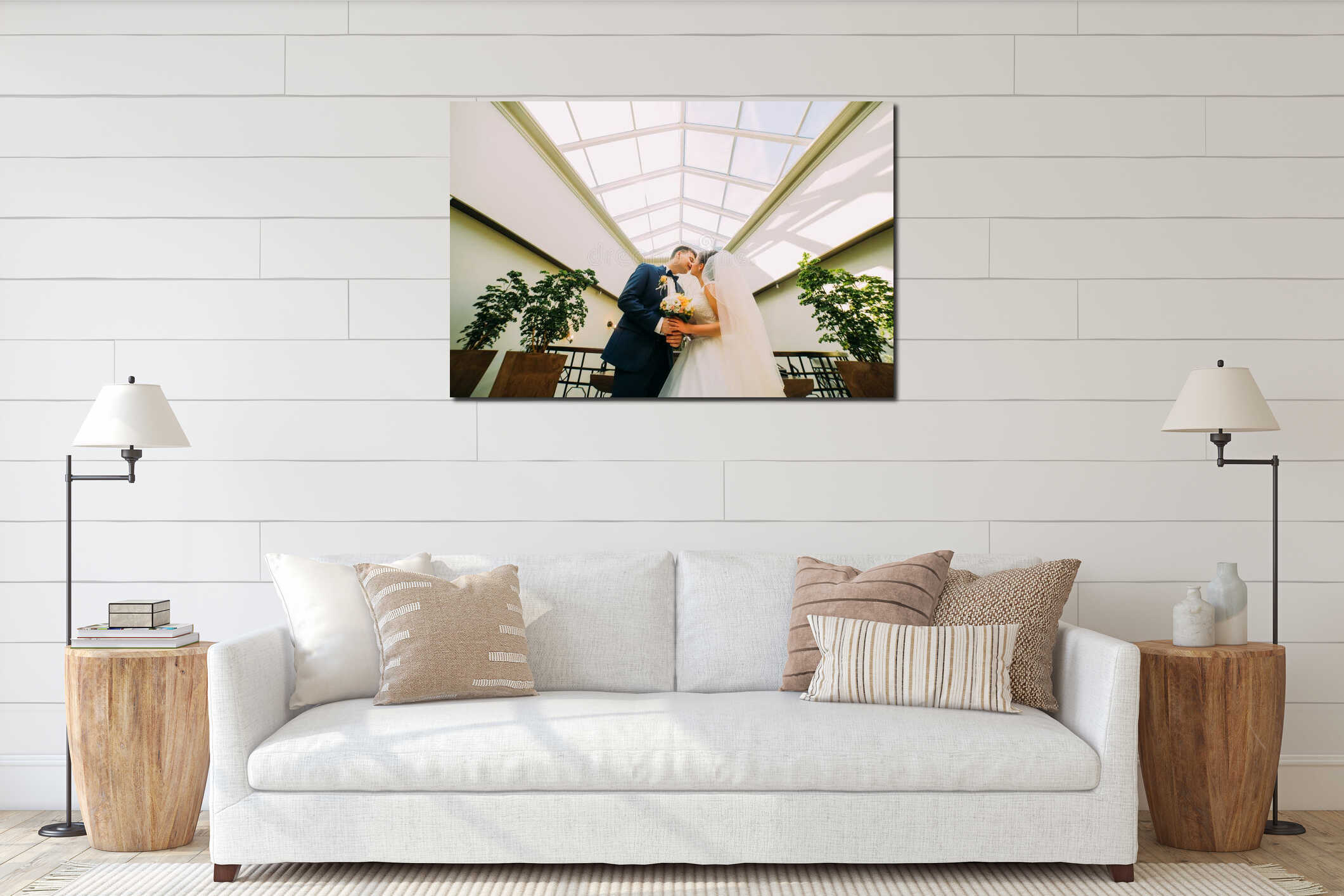 Gorgeous young bride and elegant handsome groom posing in modern background. View from below interior mockup