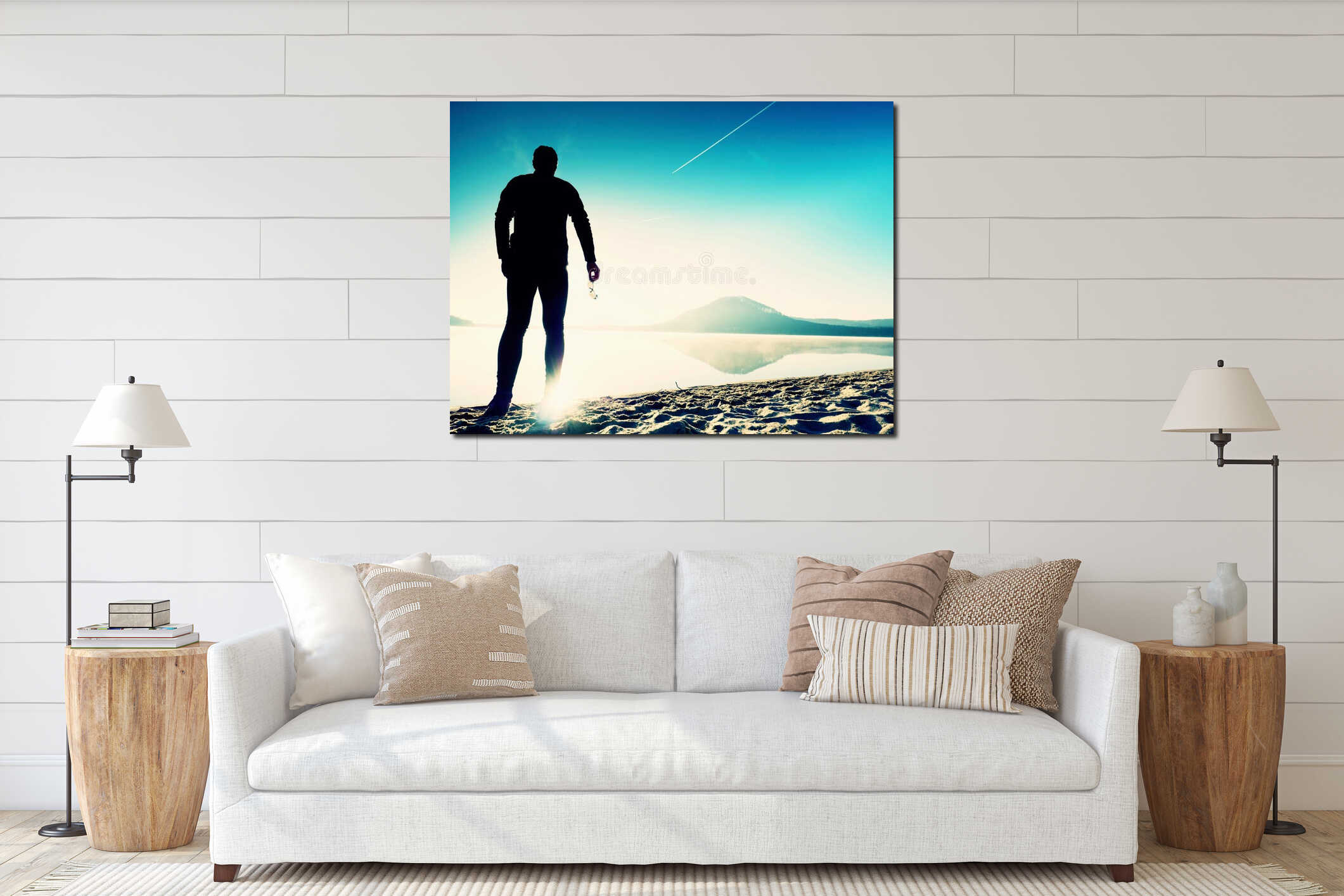 A sports man staying at the gorgeous sunset beach with glasses in hand and enjoying sunset interior mockup