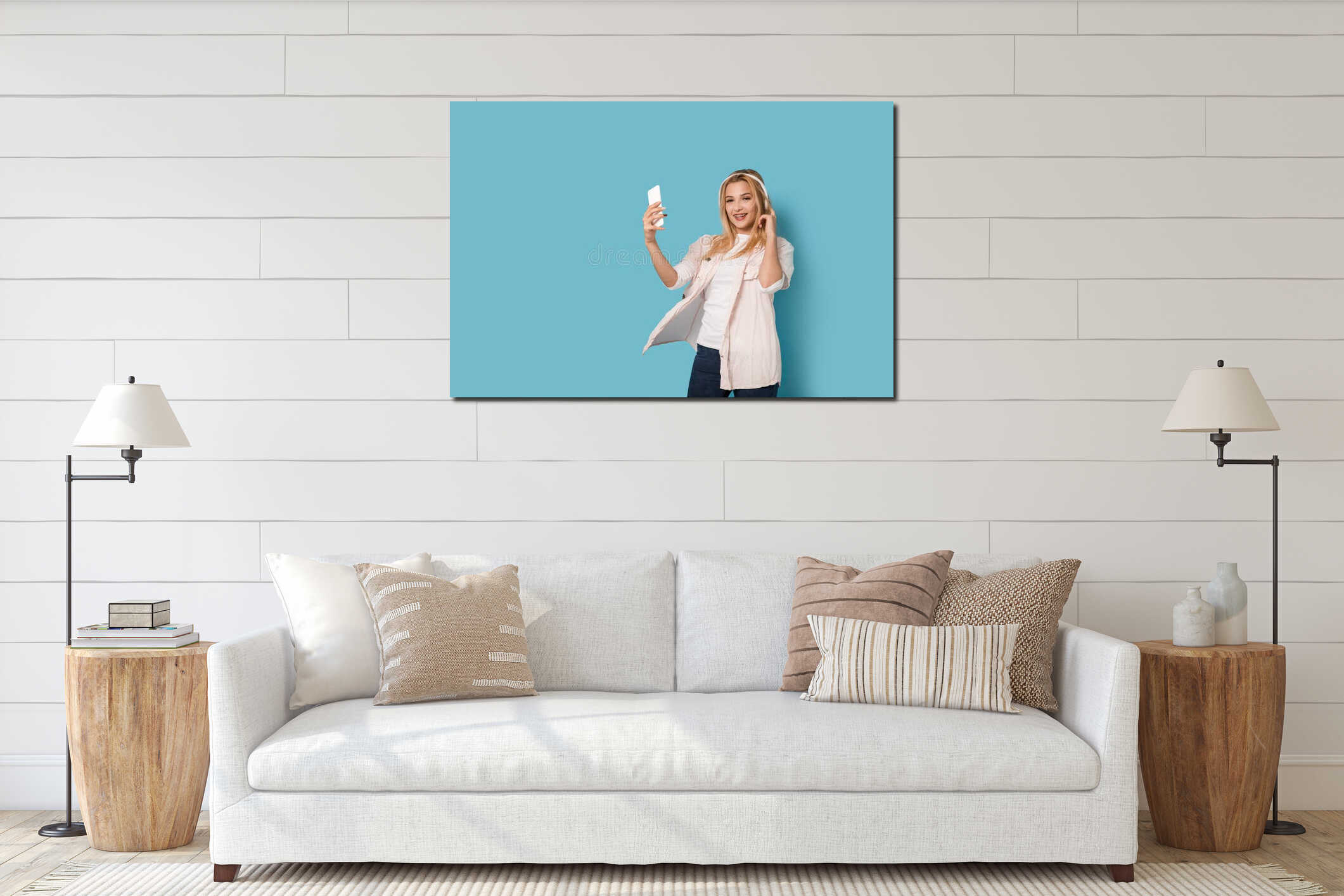 Cheerful blonde girl with smartphone smiling interior mockup