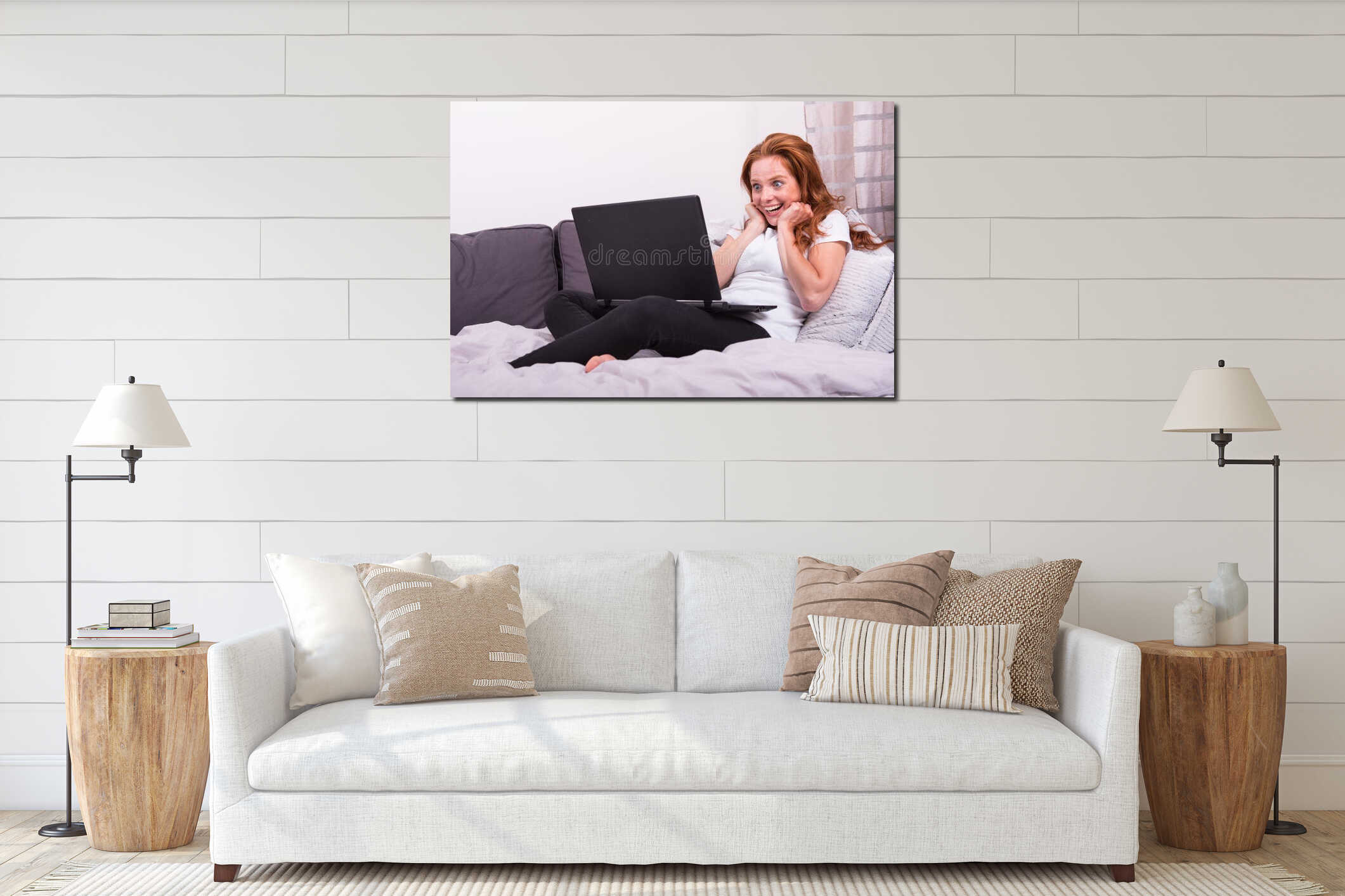 Pretty red-haired woman looking joyfully at her computer interior mockup