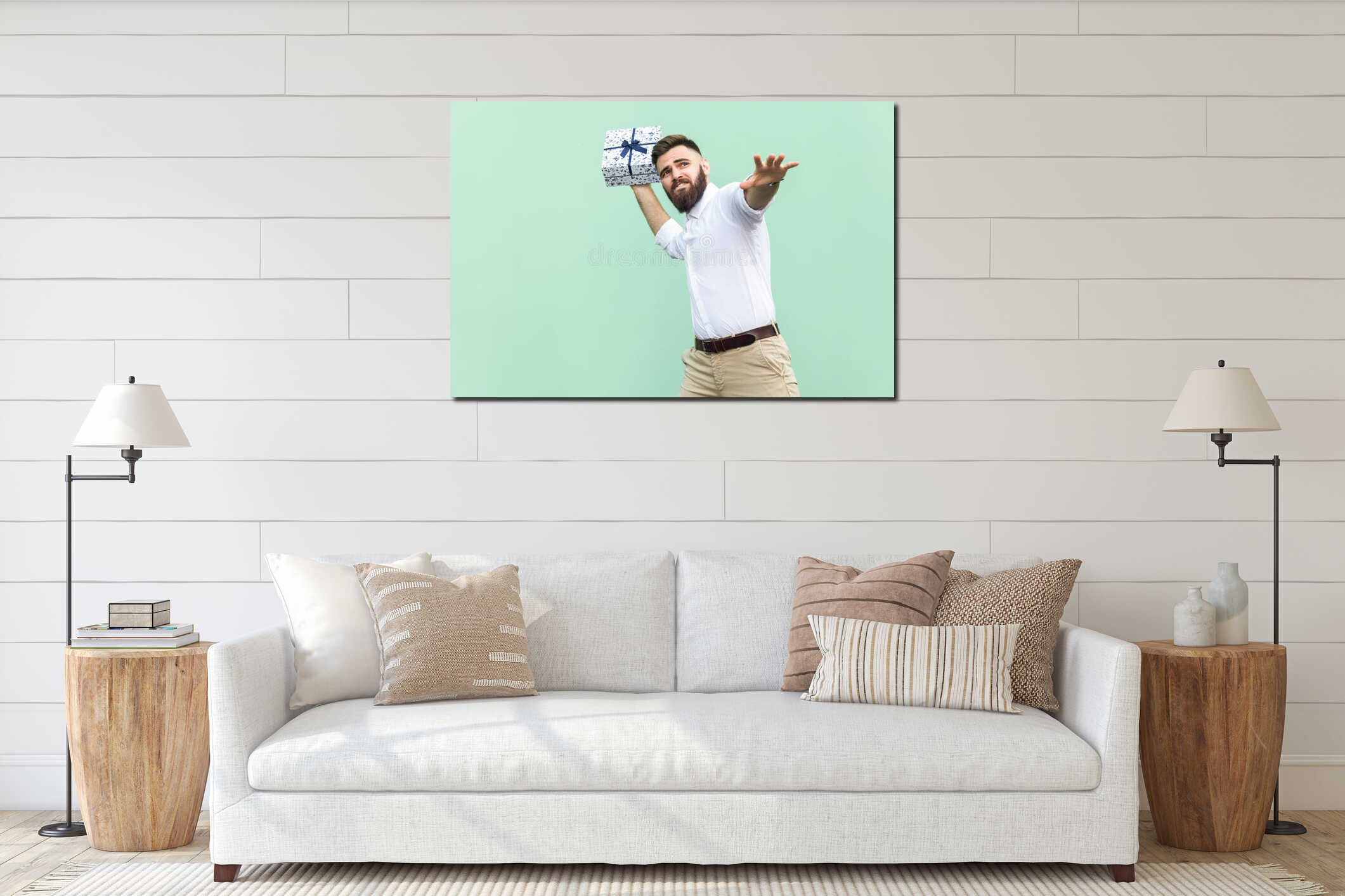 Catch your gift! Young adult man swung and wants to throw off your gift box, isolated on light green background. interior mockup
